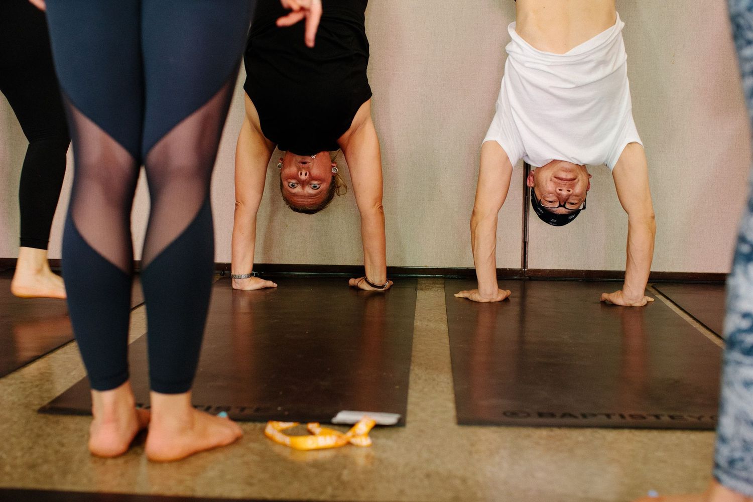 Low angle view of yoga practitioners' feet lined up during a group class.