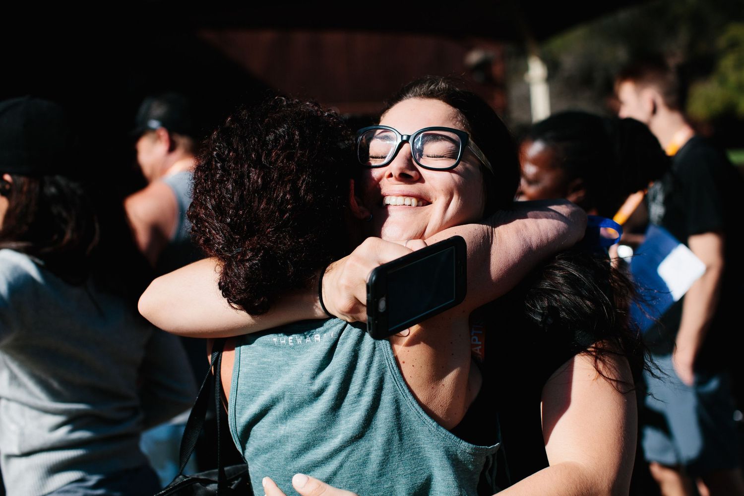 People hugging and connecting during what appears to be a group event.