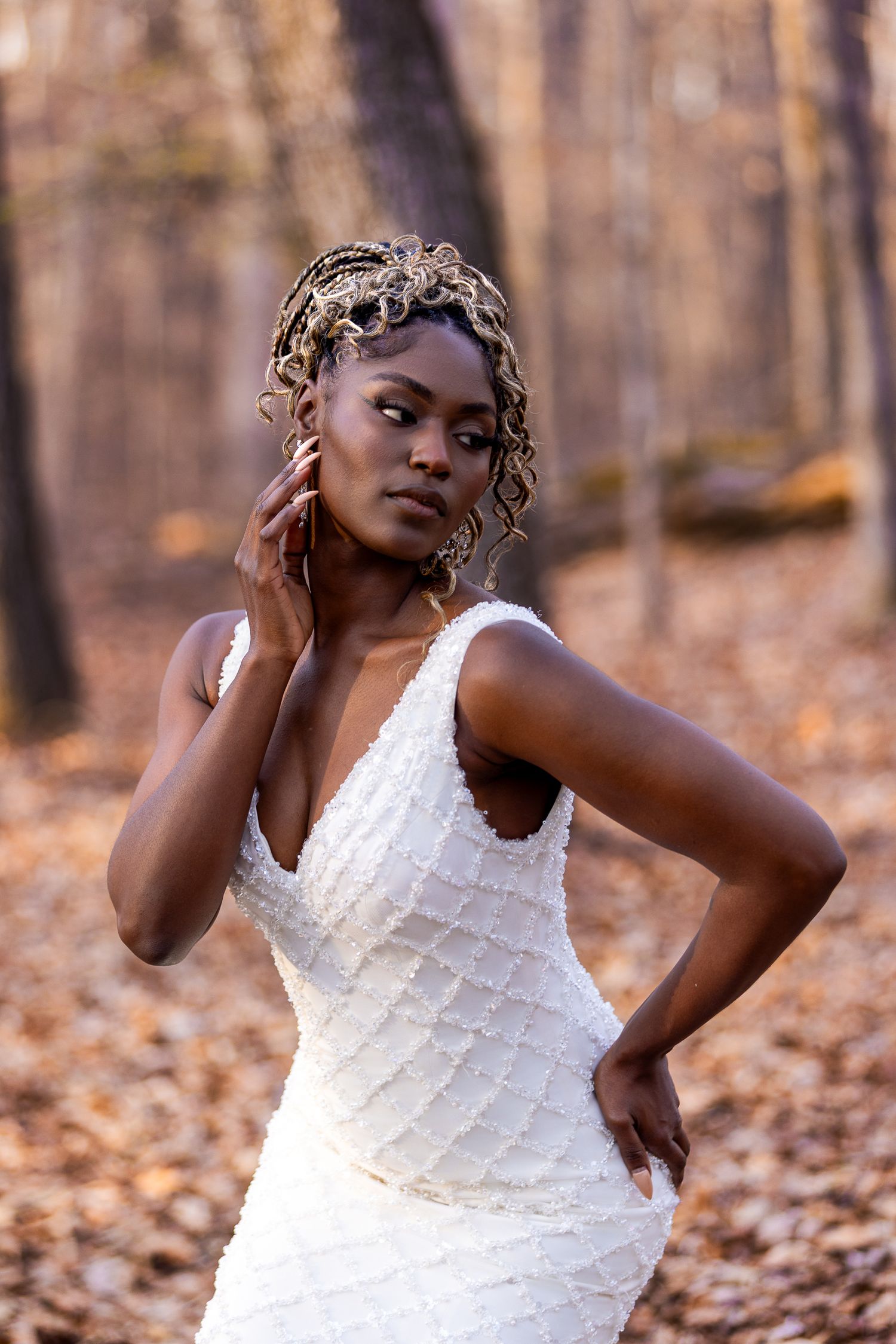 Elegant white dress showcased in artistic forest photoshoot.