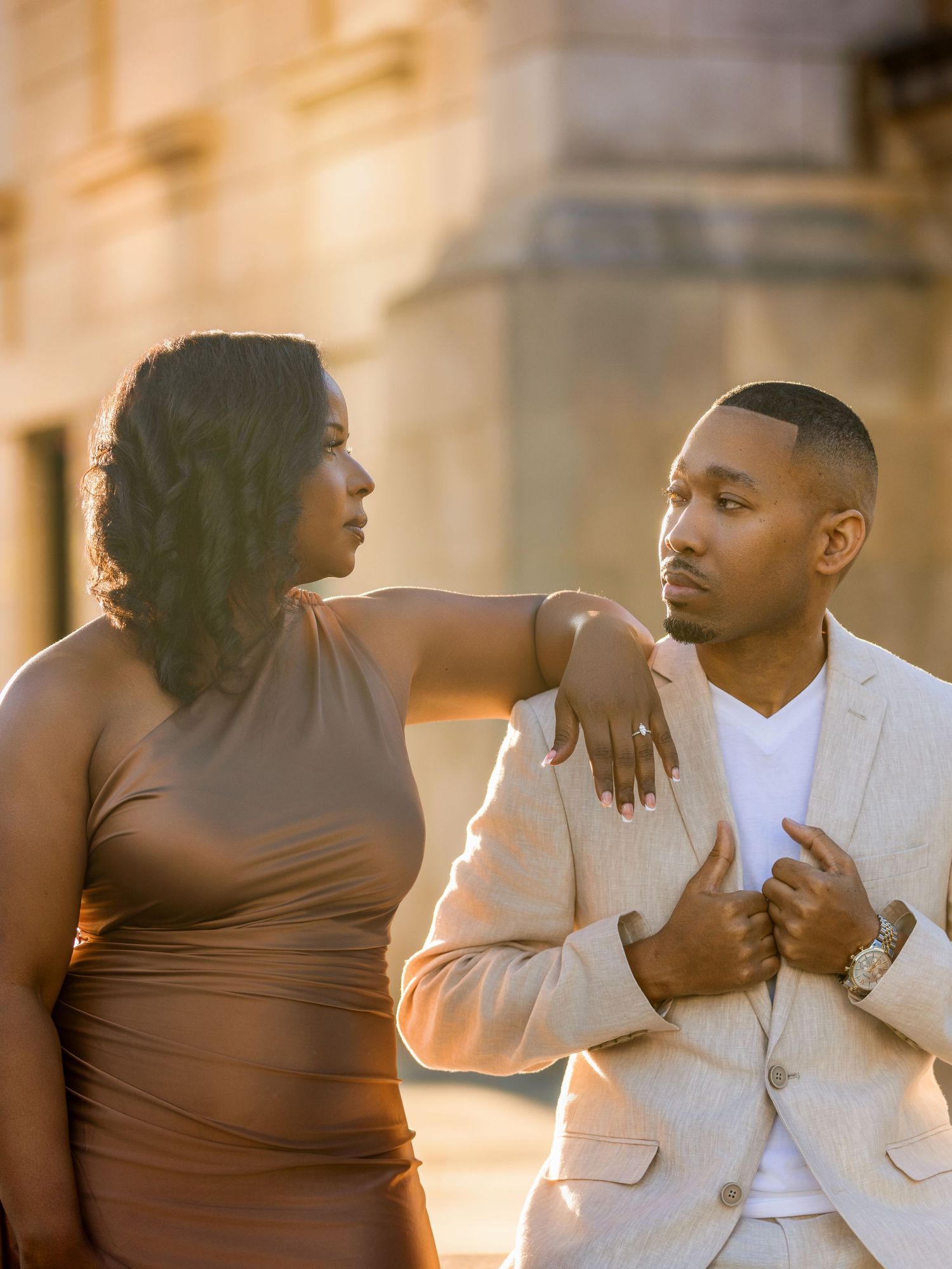 A couple shares an intimate moment in formal wear during their golden hour photoshoot.