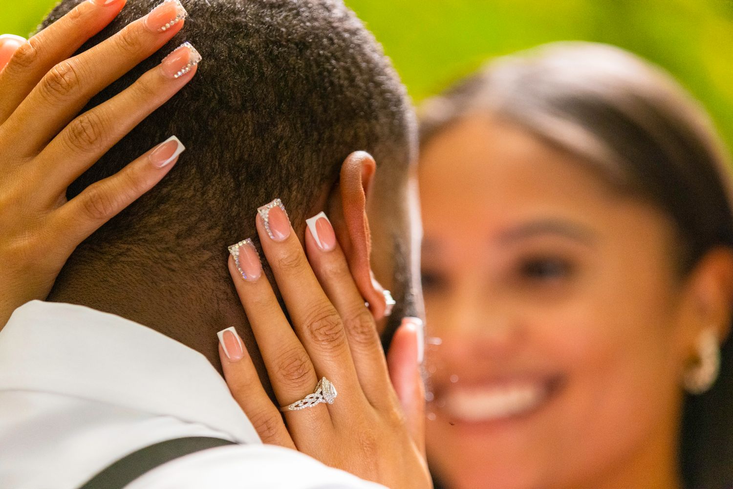 Close-up of hands showing off an engagement ring during a romantic moment.