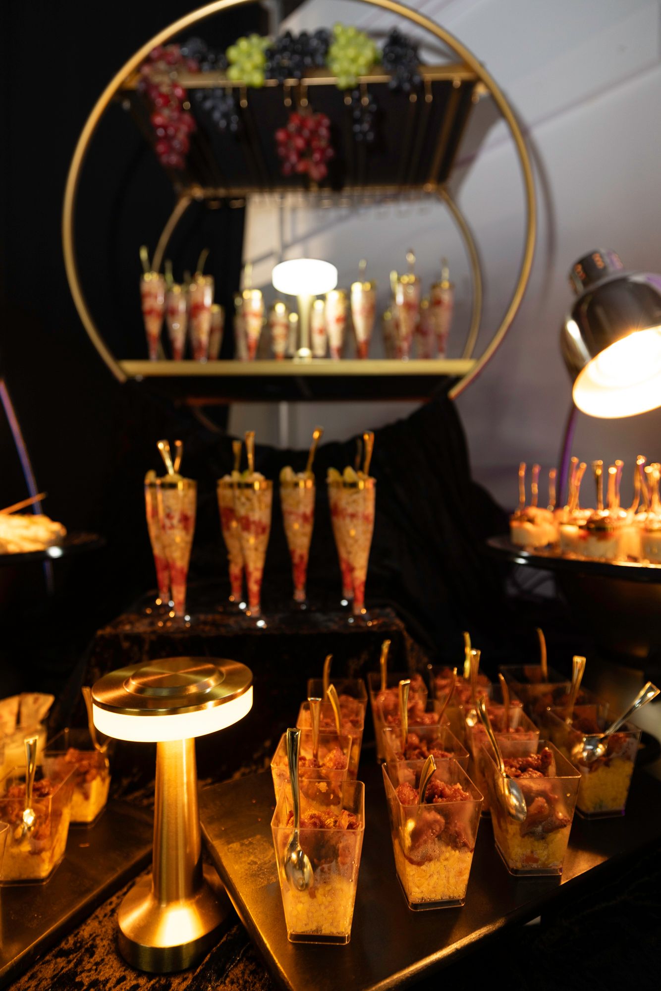 Dimly lit bar setup with glowing cocktail glasses and decorative lighting creating ambient atmosphere.