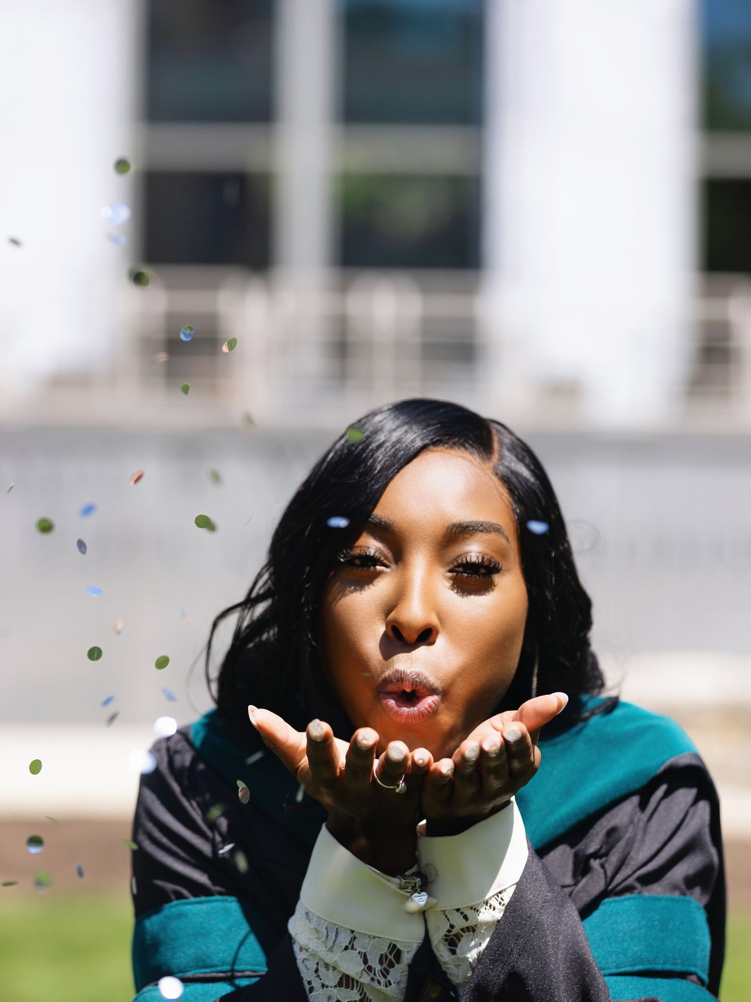 Joyful outdoor portrait with confetti and glitter in natural sunlight.