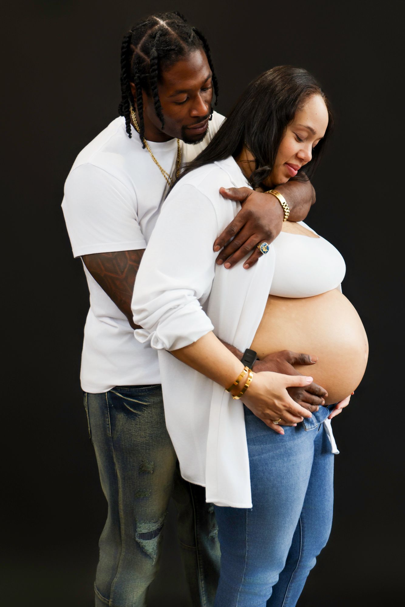 Artistic maternity photos against black background showing couple's tender moments.