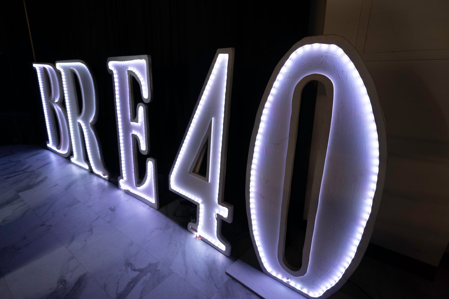 Illuminated white LED letters creating dramatic signage display.