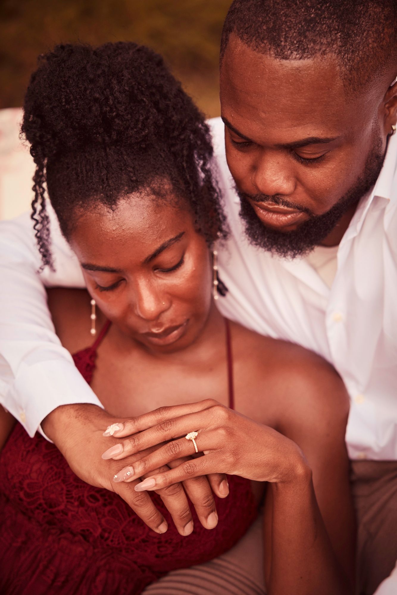 Close-up romantic shots showing engagement ring and tender moments.
