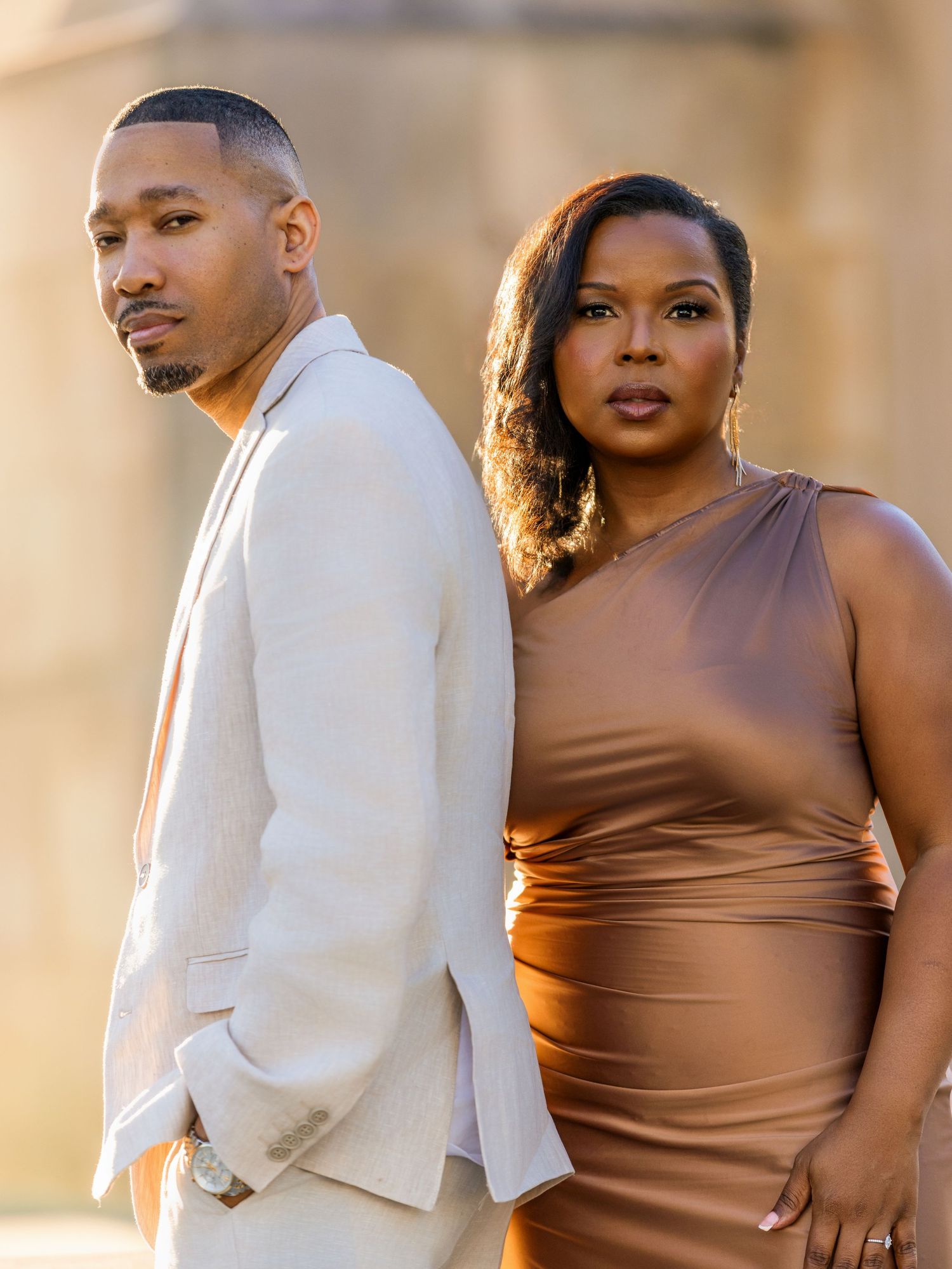 A couple poses in complementary formal wear during golden hour photography session.