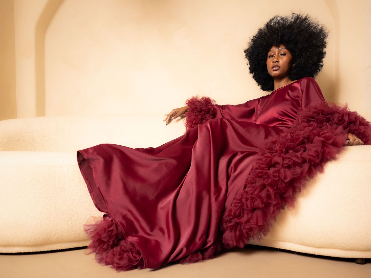 Fashion photography series featuring a flowing burgundy gown against a neutral background.