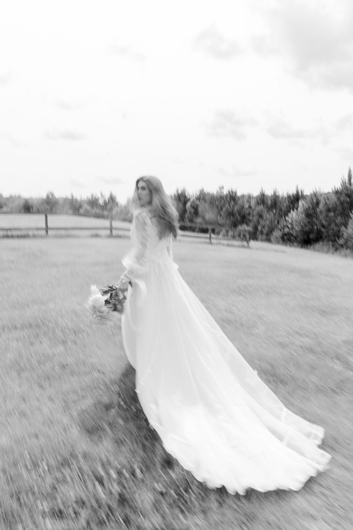 Bride running in a field..