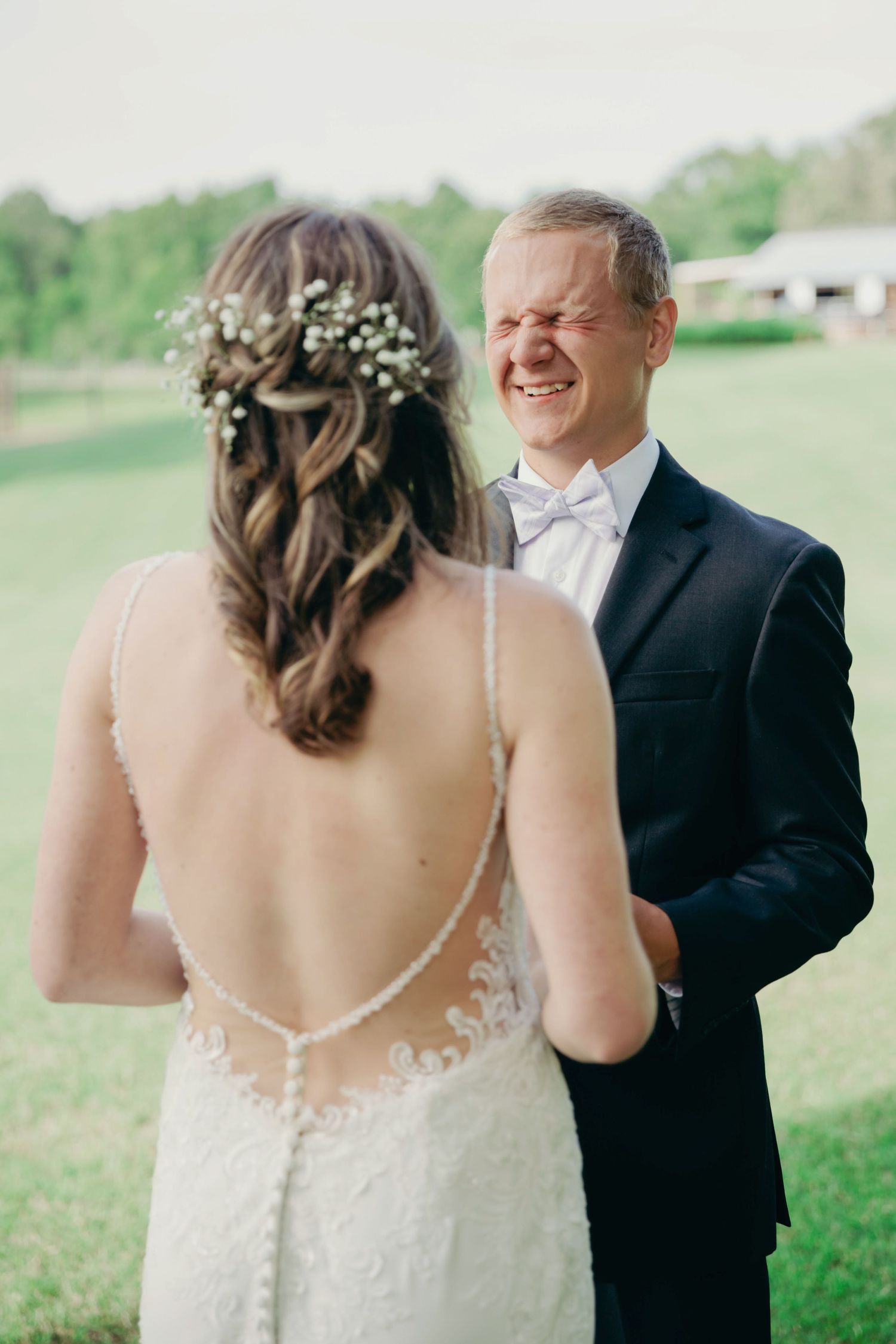 Groom laughing with his bride.