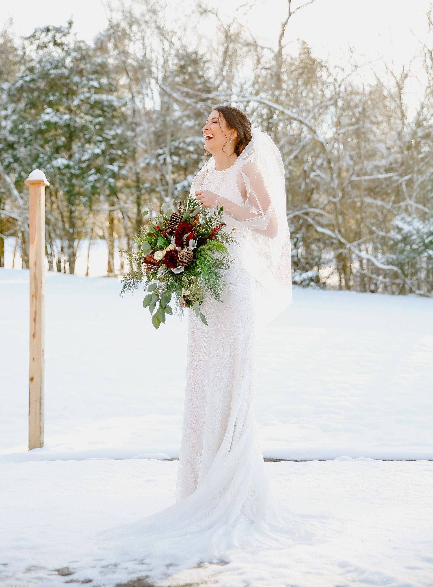 Bride laughing in the snow.