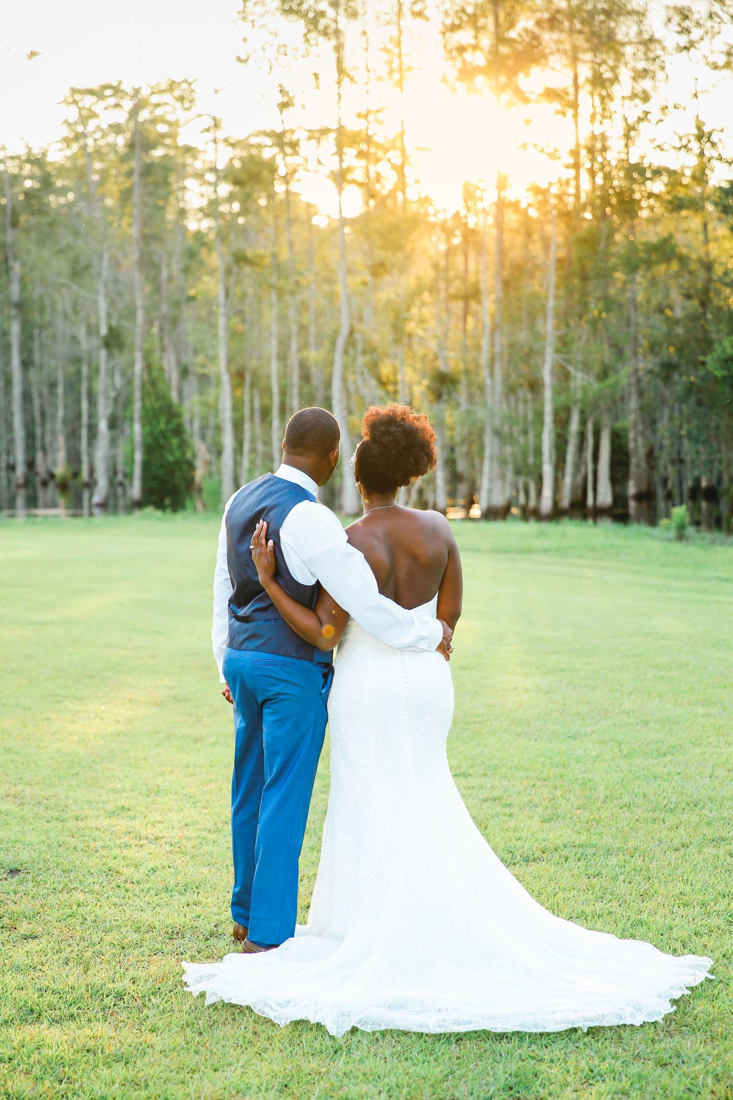 Bride and groom looking at sunset.