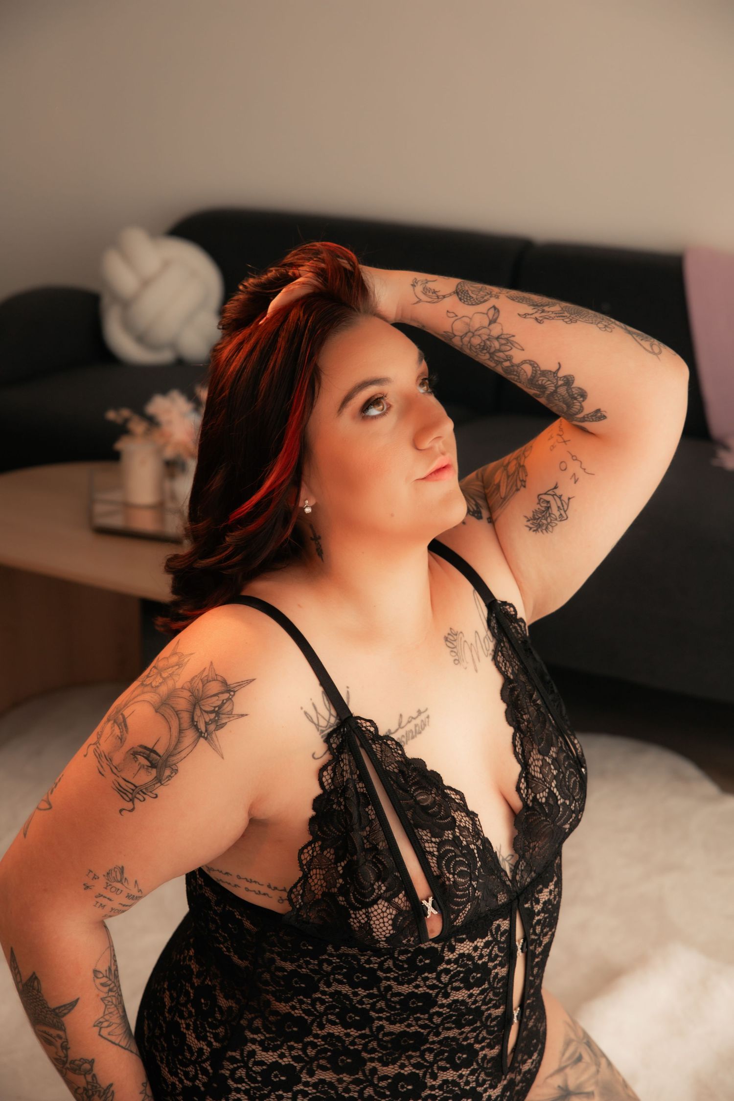 woman in boudoir pose who had her hands through her hair