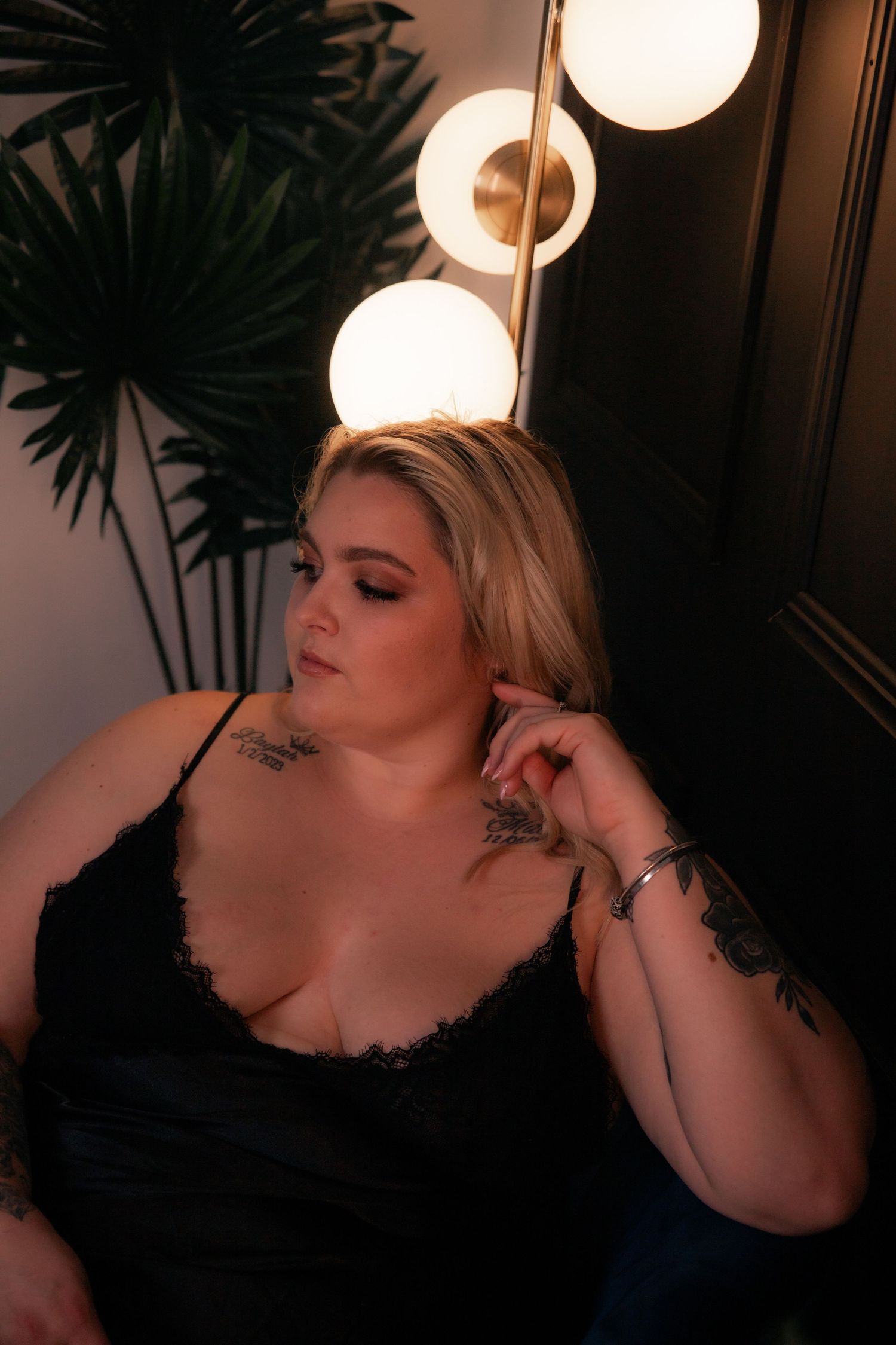 woman posing on a velvet chair in lingerie boudoir
