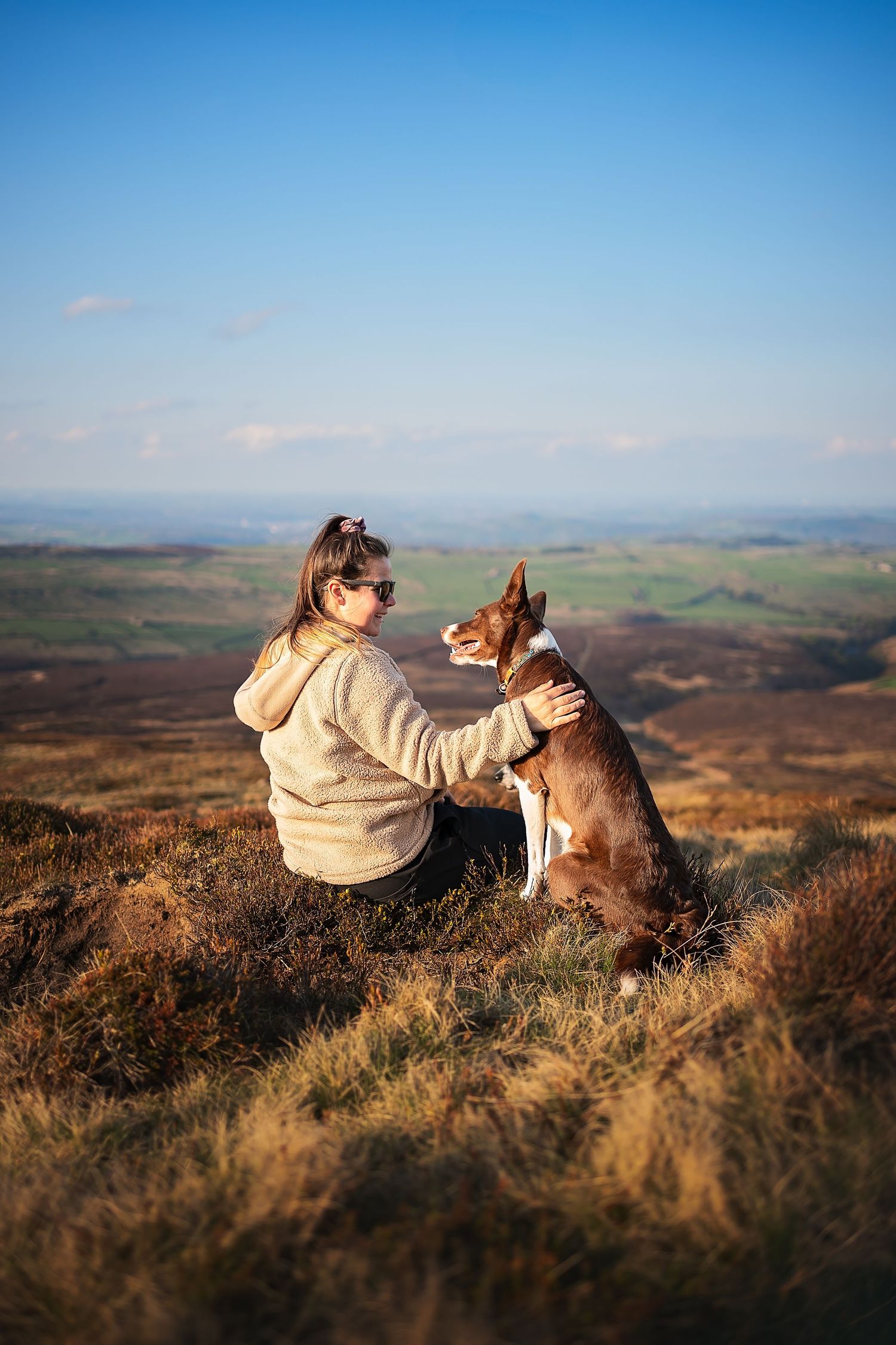 owner and dog cuddling in the peak district