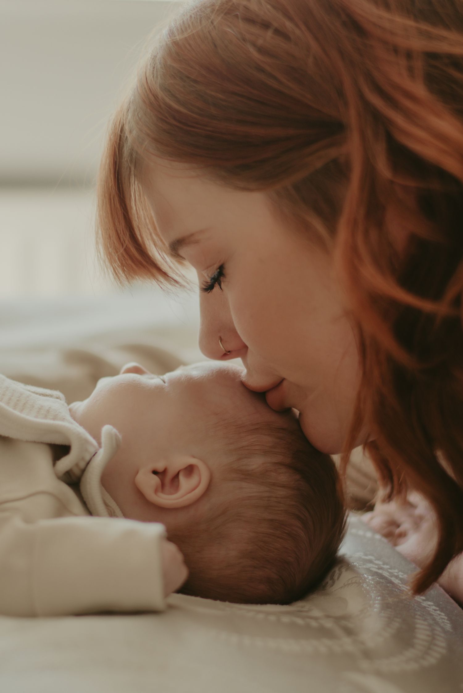 Tender moment captured in soft, intimate lighting between parent and child.