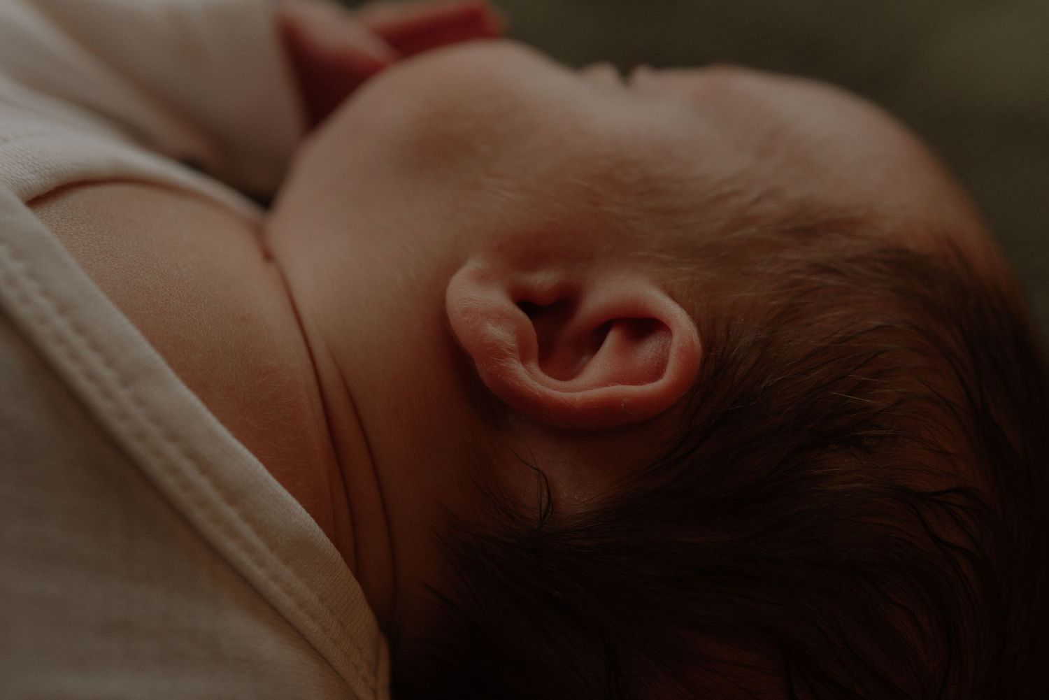 A series of six close-up photographs showing a baby's face from different angles in soft lighting.