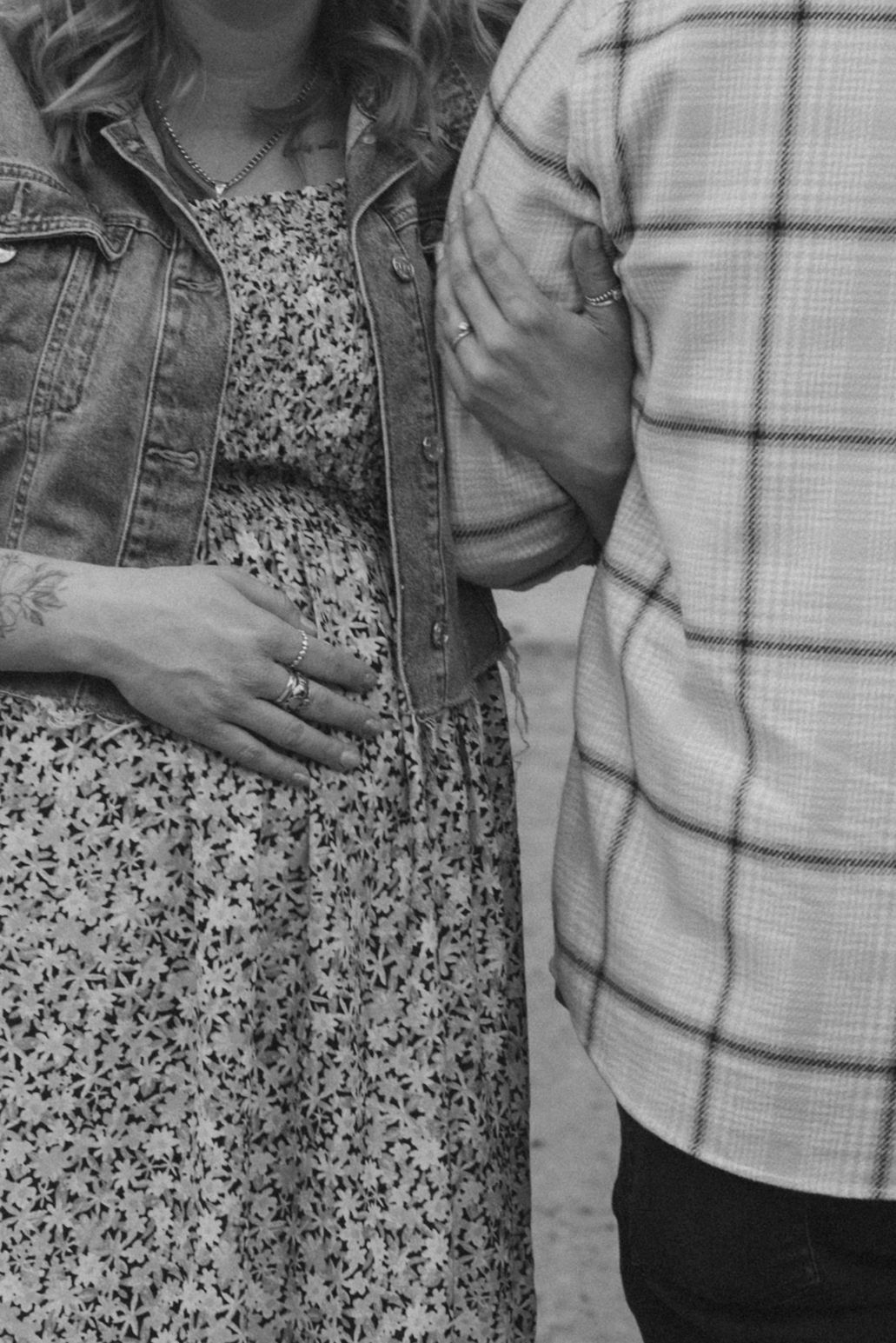 Black and white photo showing close contact between two people in a tender embracing pose.
