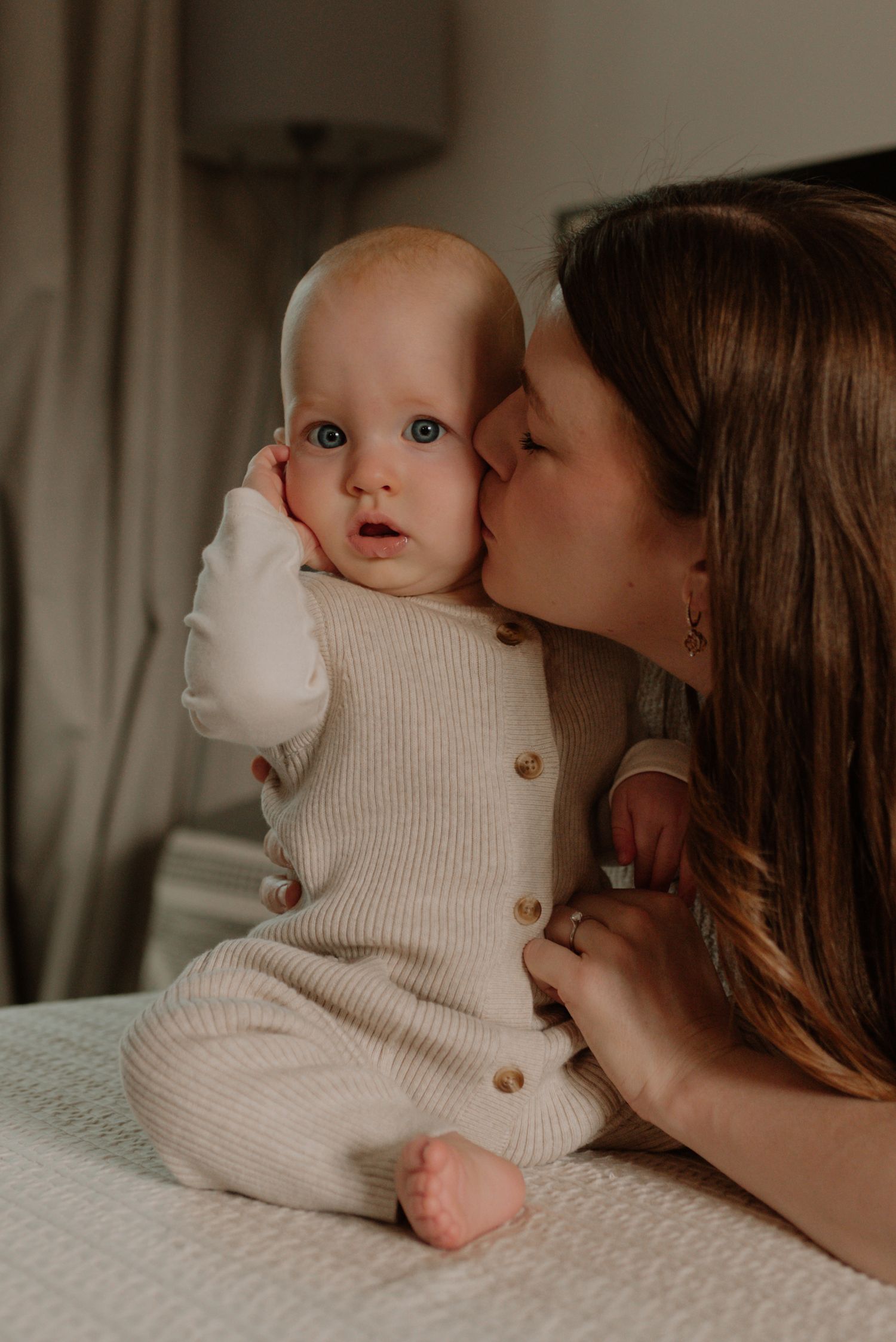 A tender moment captured in a series of intimate photos showing affection and connection in soft, warm lighting.