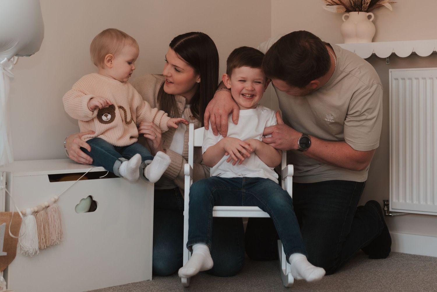 Family playtime captured in candid black and white photos at home.