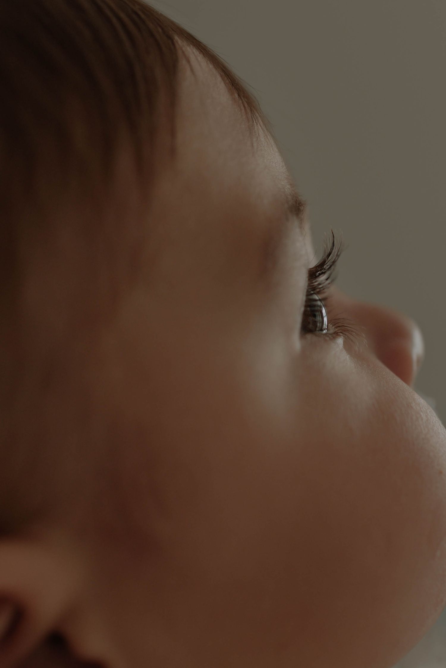 A series of cropped profile views showing a person's facial features in a soft, muted lighting.