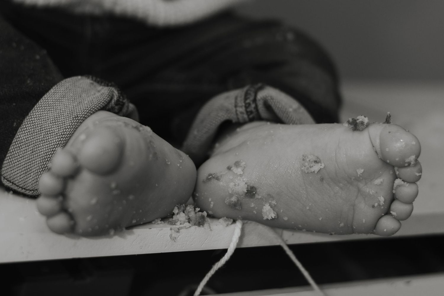 Close-up shots of tiny baby feet in black and white.