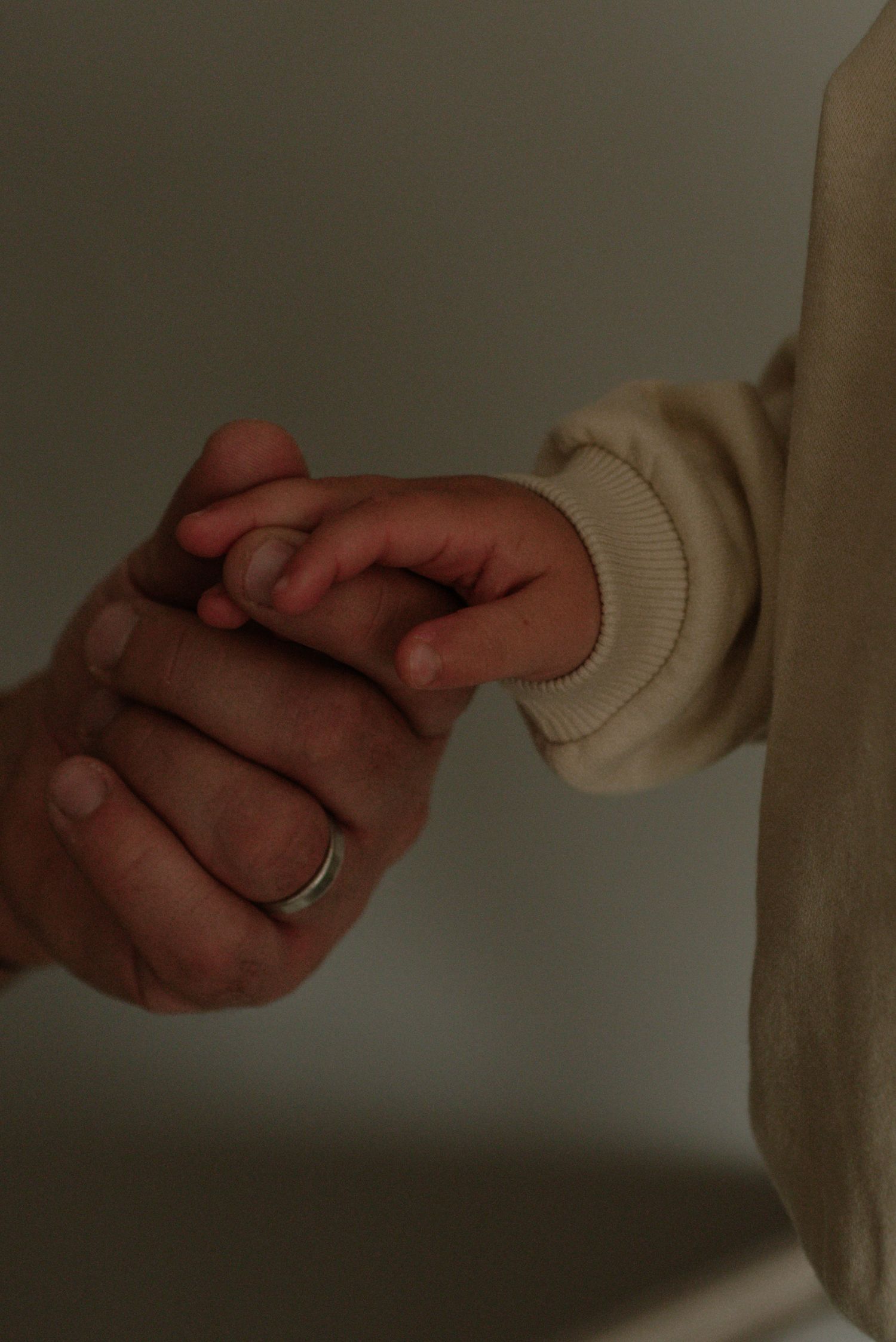 Close-up series of hands pulling apart white fabric showing progressive stages of stretching and tearing motion.