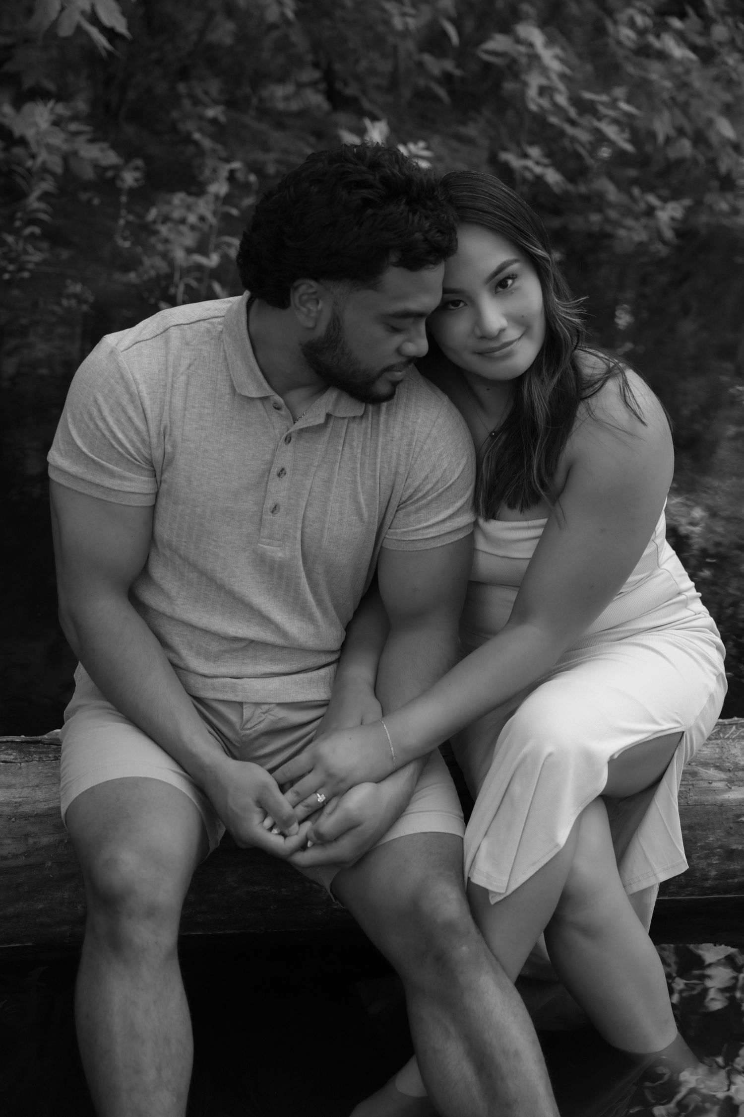 Newly Engaged couple snuggles and holds hands for a soft moment together during their outside engagement session in Stillwater, MN.