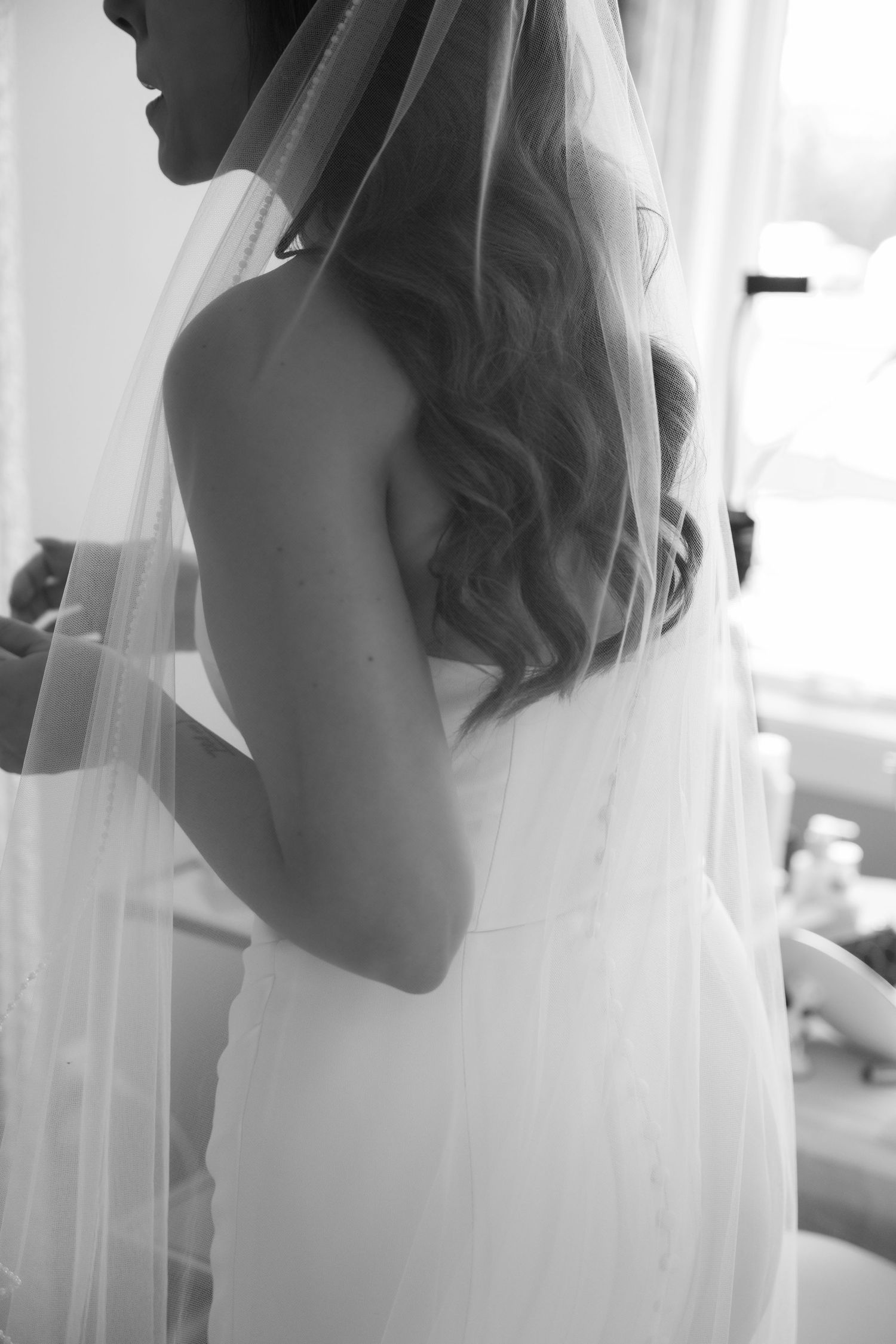 bride getting ready, details of dress and veil at a backyard vineyard wedding in hudson wisconsin