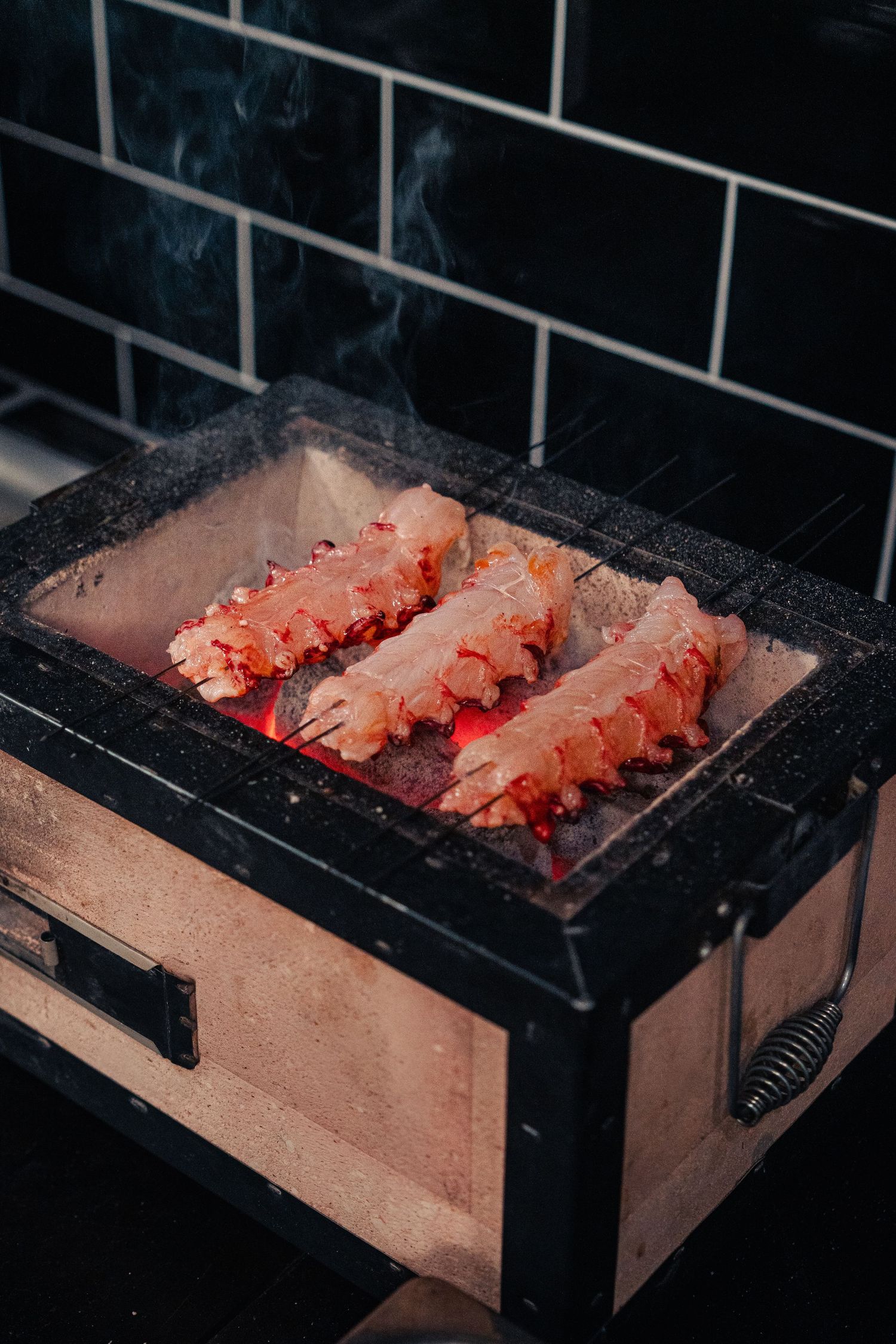 Lobster tails being barbecued on a kasai BBQ