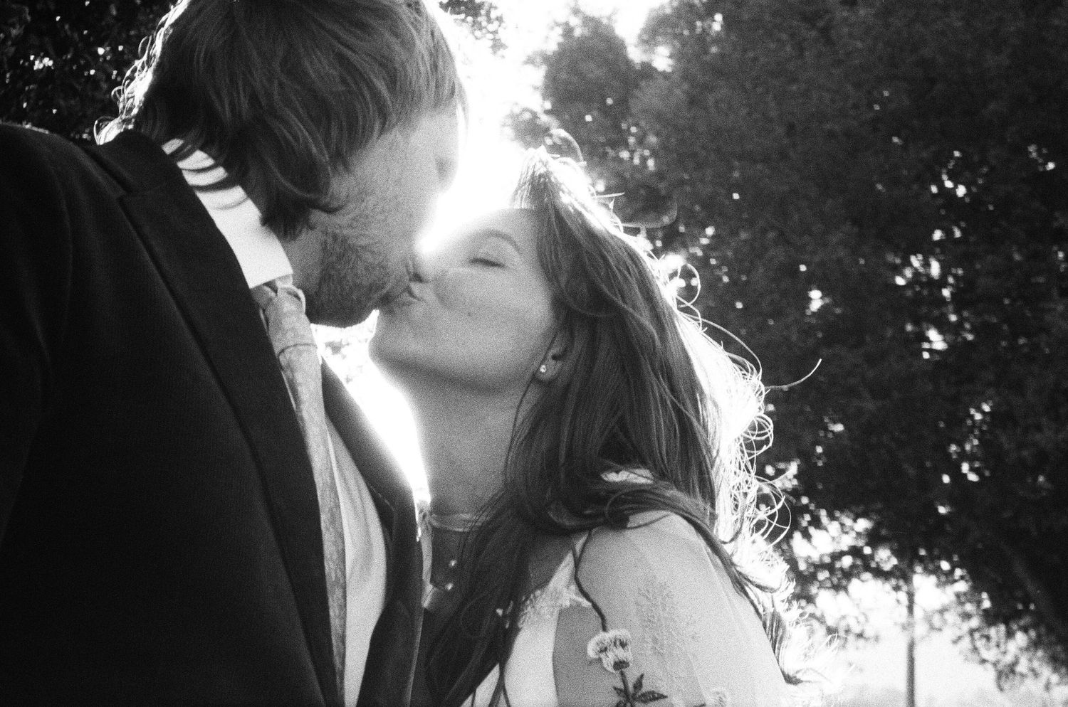 Sunlit wedding photography sequence capturing intimate moments in a garden setting. Photographed on film in the North Bay