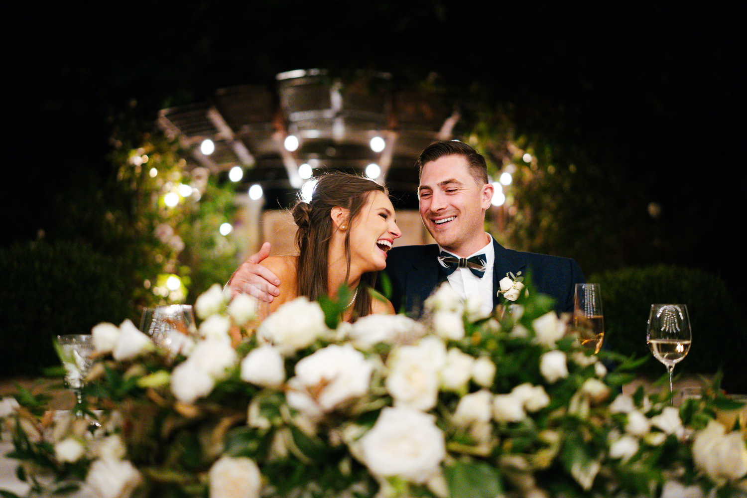 Elegant wedding reception table setting with white floral arrangements and candlelight at Cornerstone Sonoma.