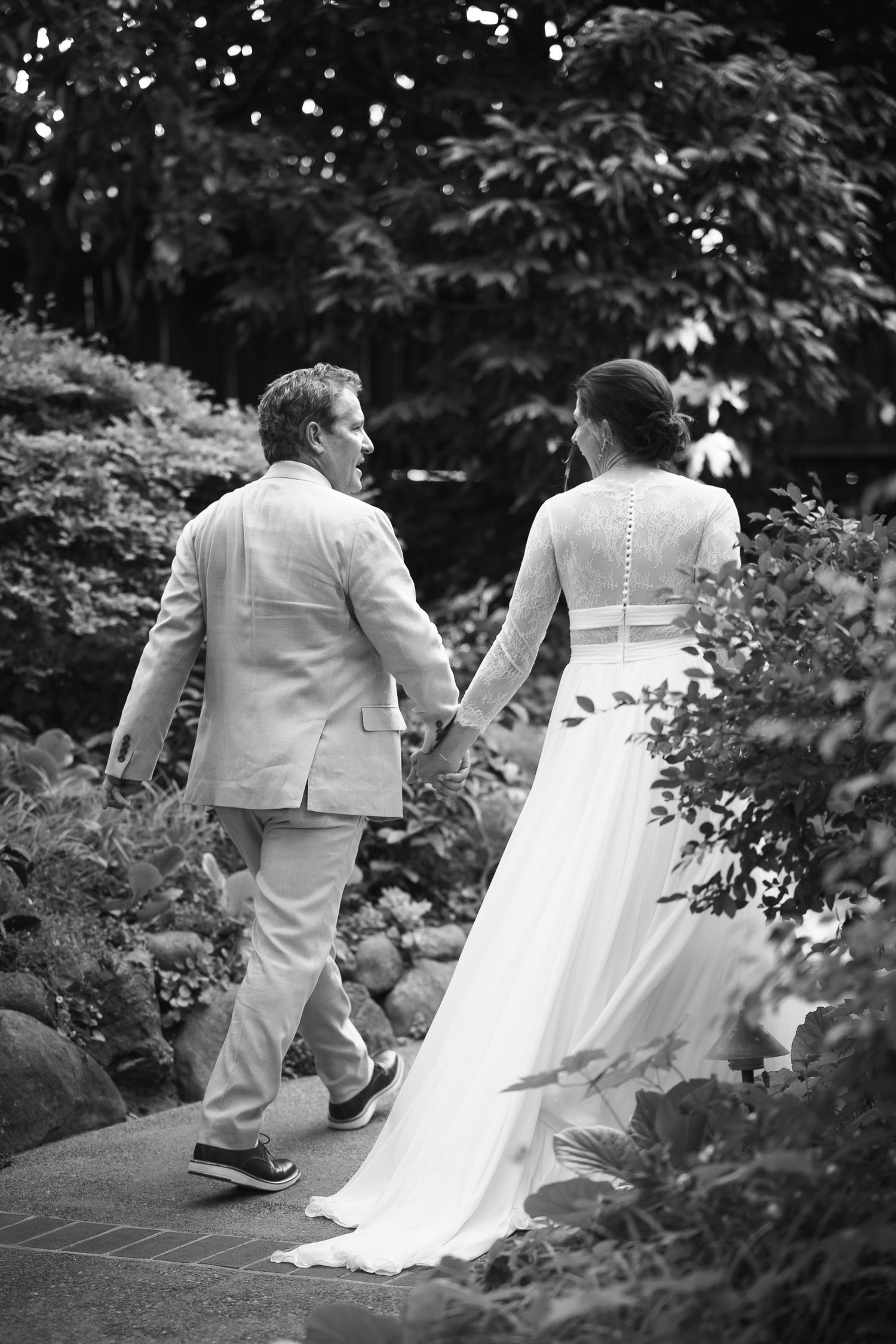 A black and white wedding sequence shows a couple walking up garden steps together in formal attire.