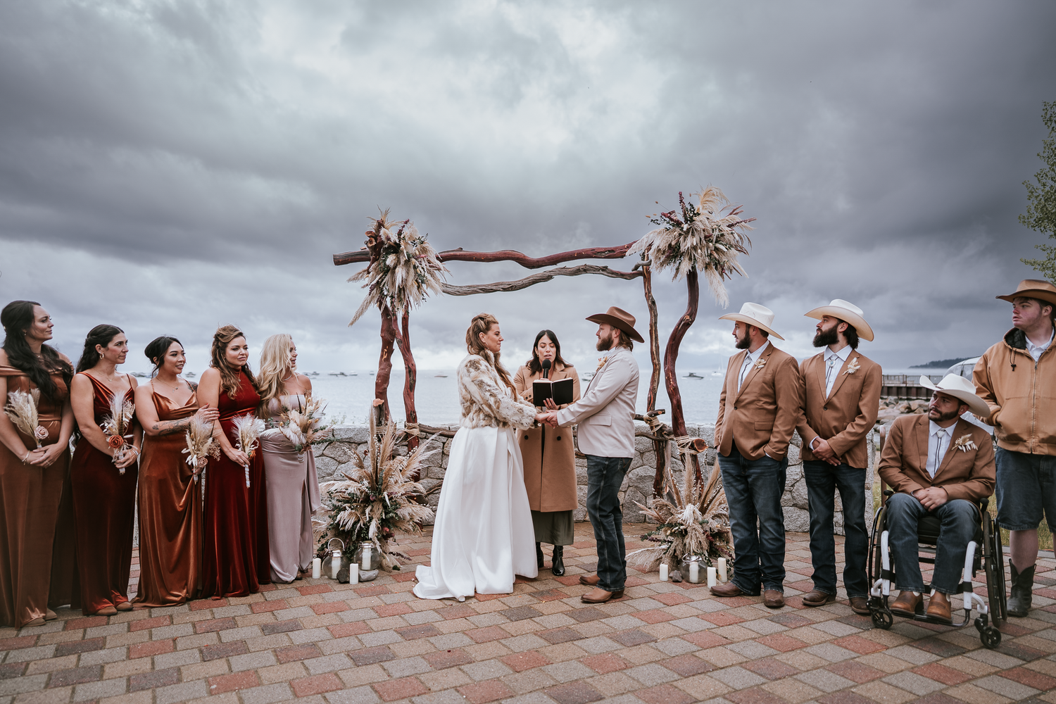 Wedding ceremony under dramatic cloudy sky with rustic desert alter in Lake Tahoe, California.