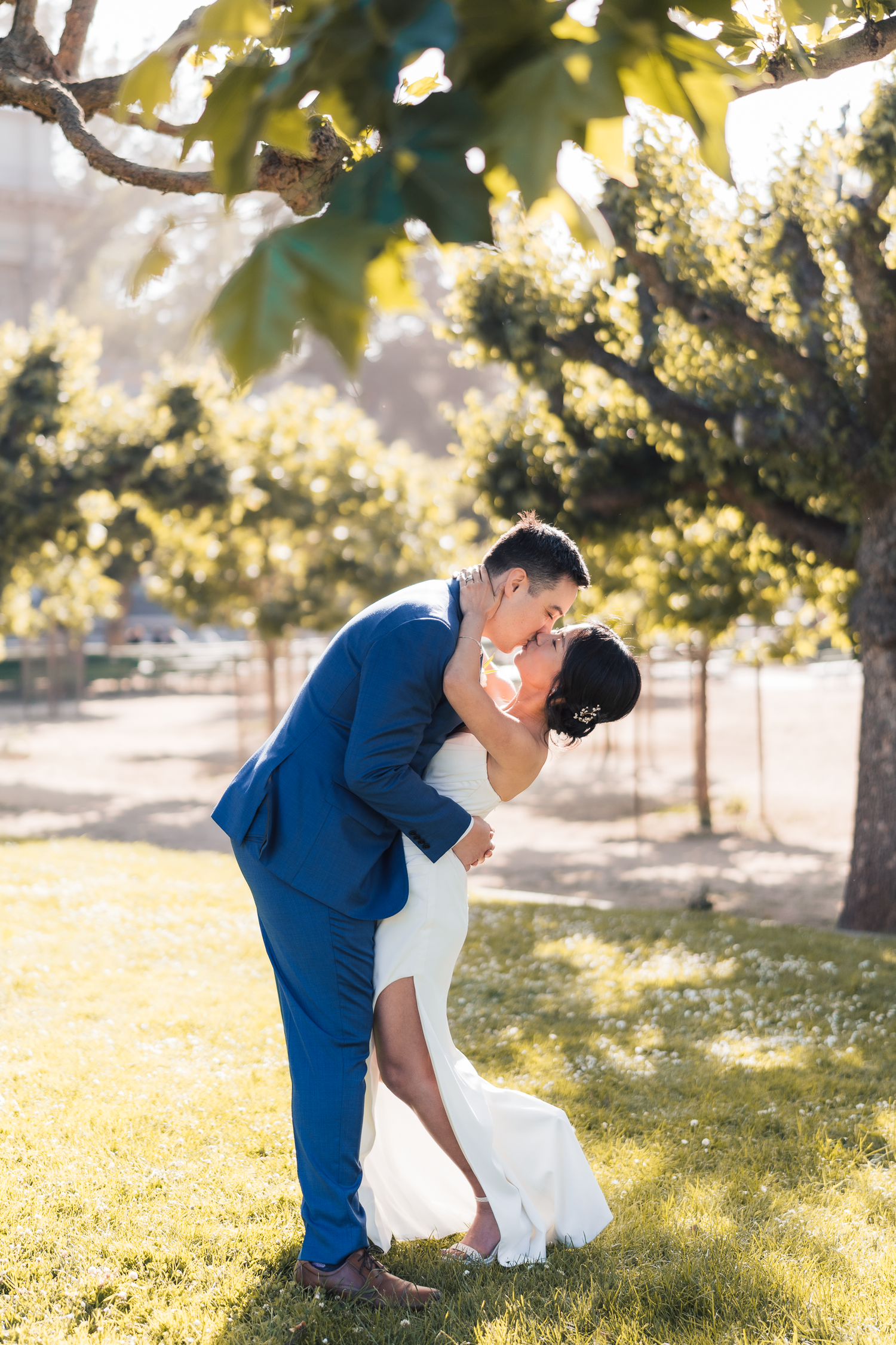 Romantic wedding couple sharing intimate moments in a sun-dappled garden setting in San Francisco.
