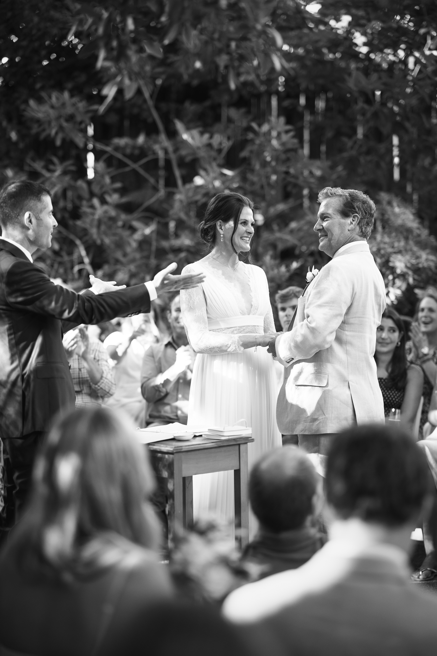 Black and white photo sequence showing a couple dancing and celebrating at an outdoor wedding reception.