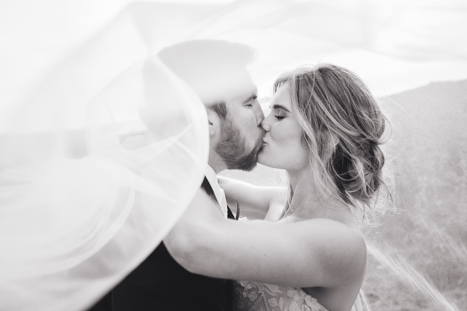 An intimate black and white wedding portrait capturing a romantic moment between newlyweds at Olympia's Valley Estate in Petaluma.