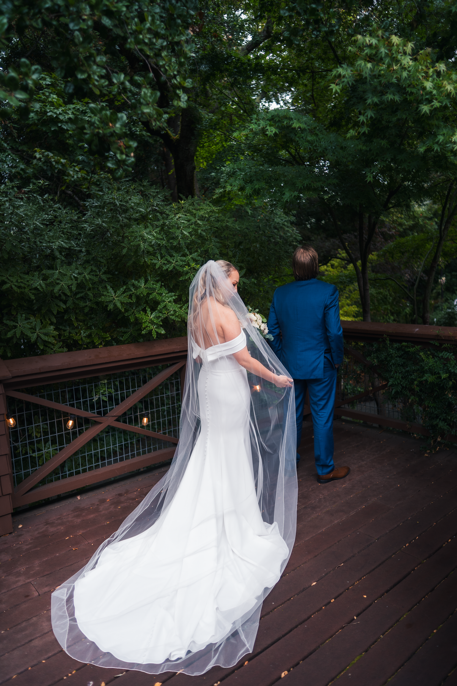 First look on wooden deck surrounded by lush greenery at the Outdoor Art Club in Mill Valley, California.