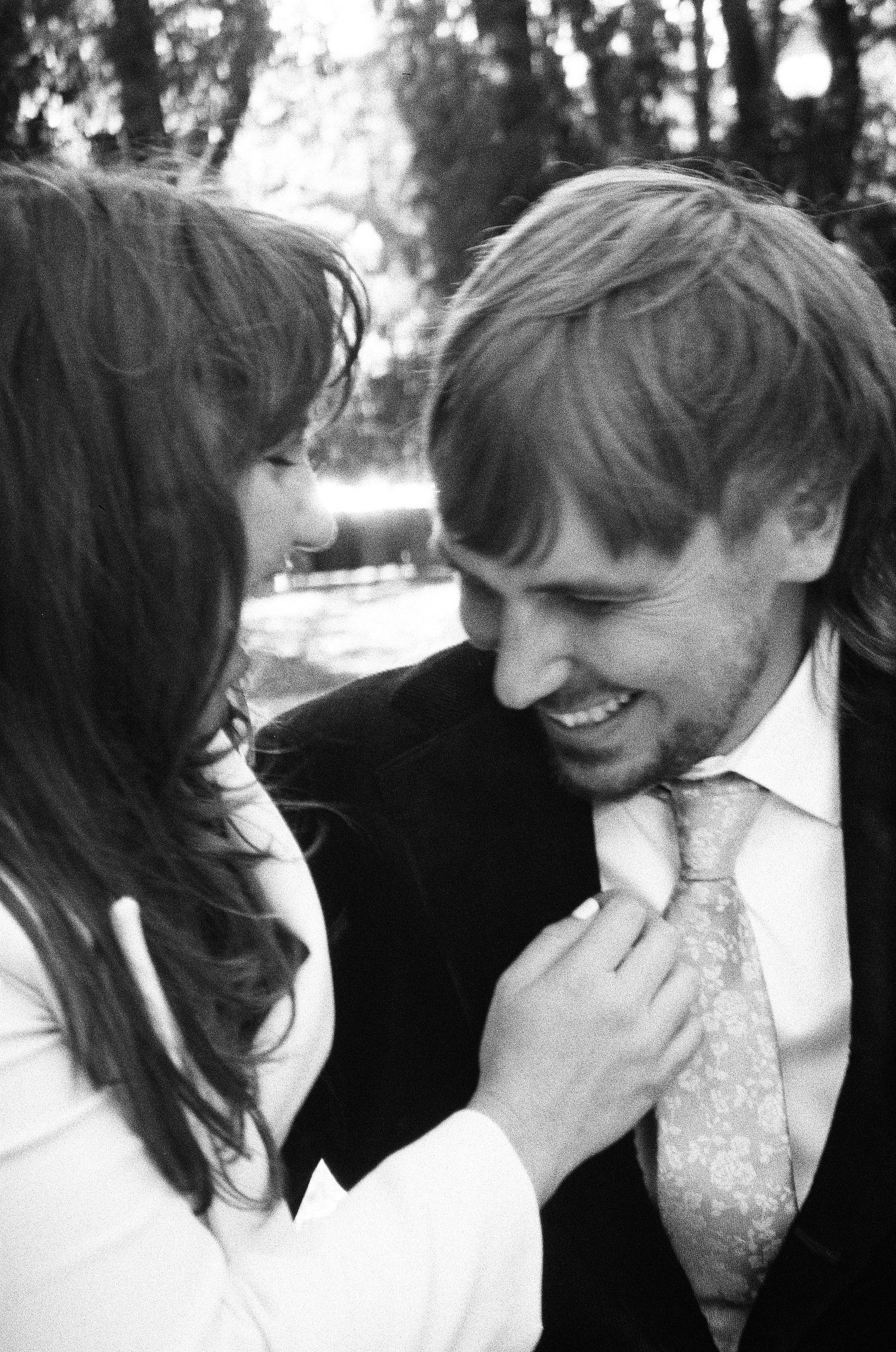 Black and white romantic photo sequence showing intimate moments between a couple outdoors. Photographed on film in the North Bay