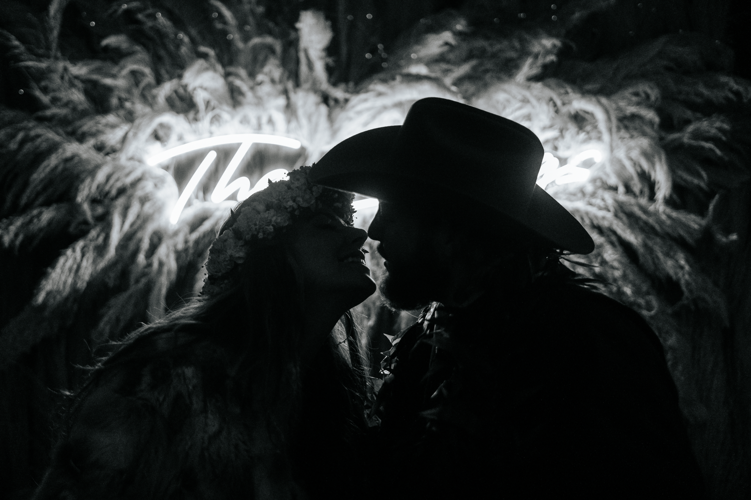 Silhouettes against bright light create a dramatic nighttime scene with illuminated smoke or fog.