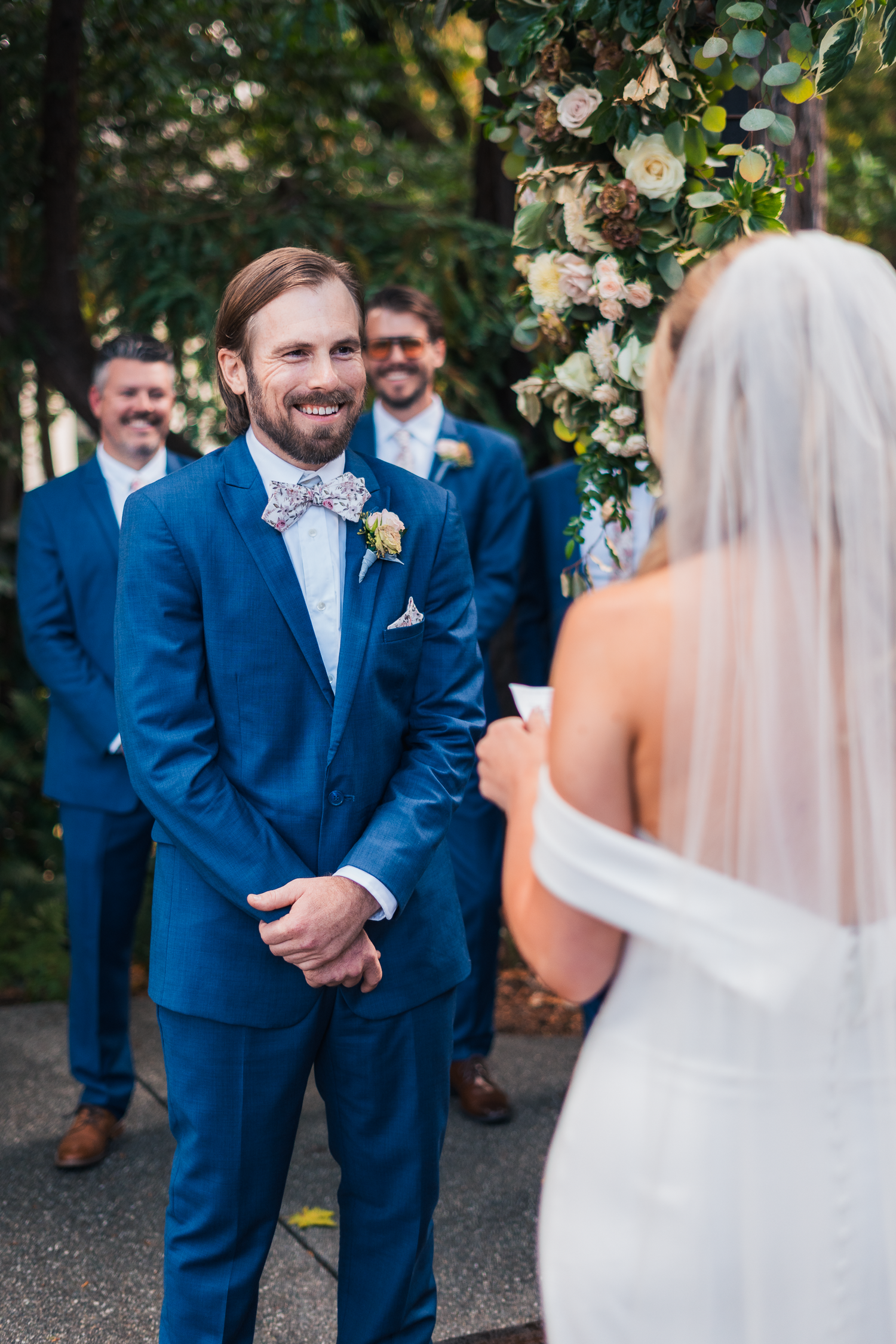 Wedding party in bright blue suits standing outdoors during a ceremony at Cornerstone Sonoma.