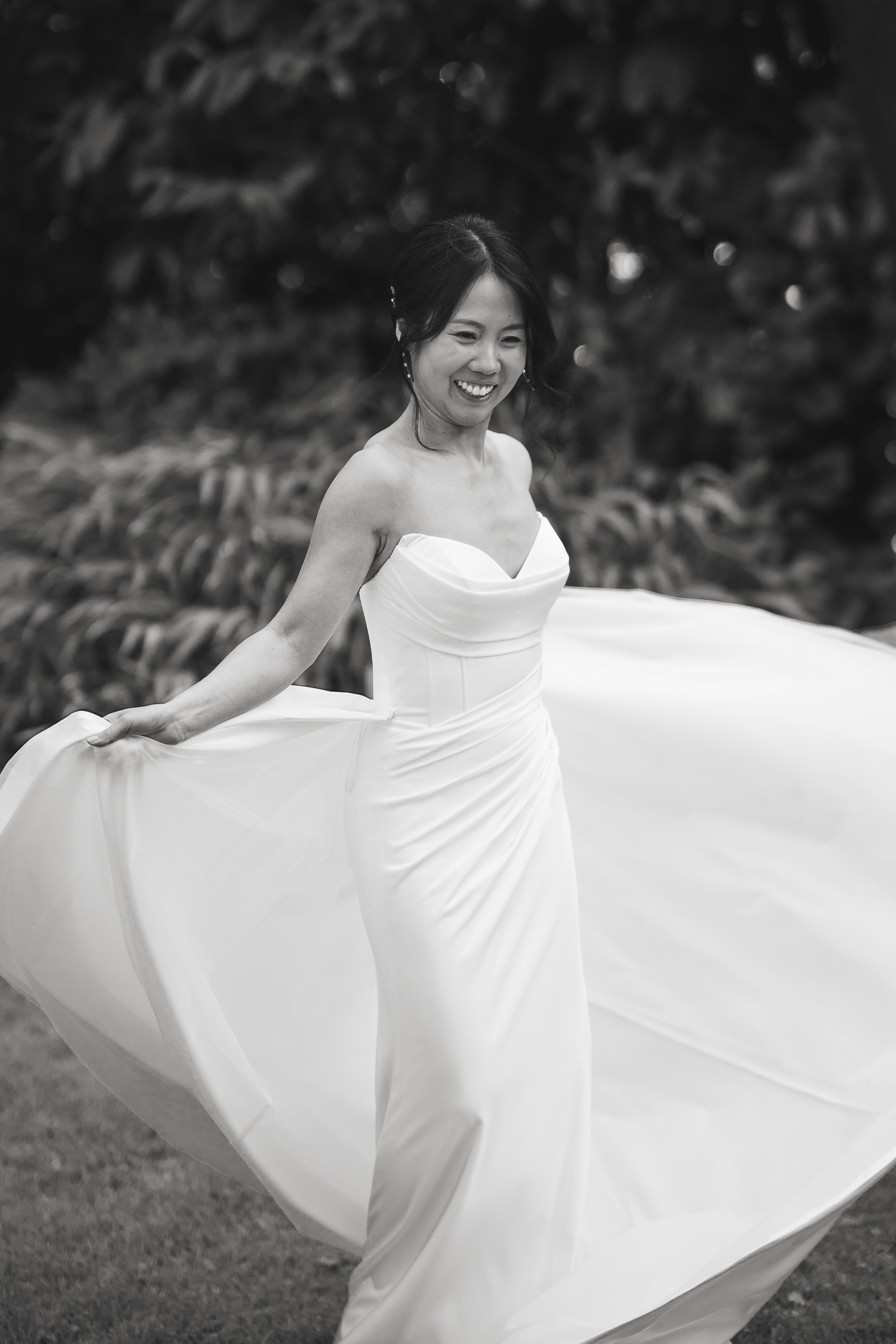 Black and white photo of a bride twirling in a flowing wedding dress in San Francisco.