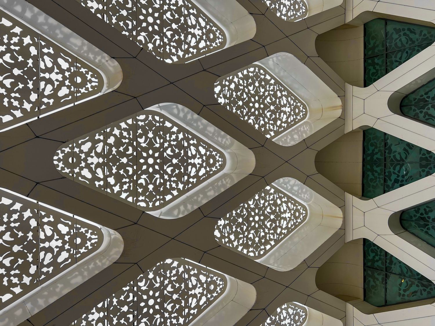 Geometric ceiling details with intricate Islamic patterns in modern architectural design.