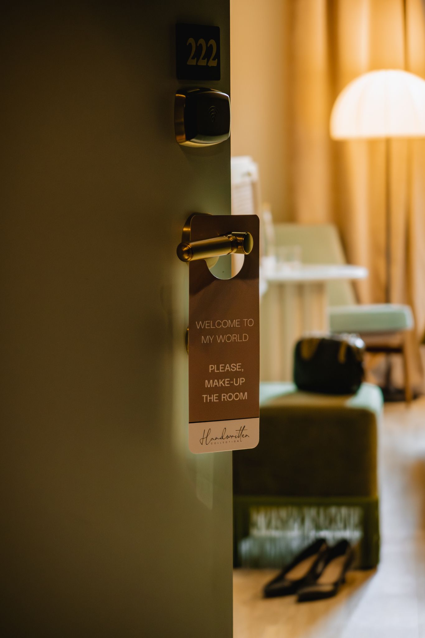 A series of hotel door signs with room numbers and welcome messages shown in warm lighting and shallow depth of field.