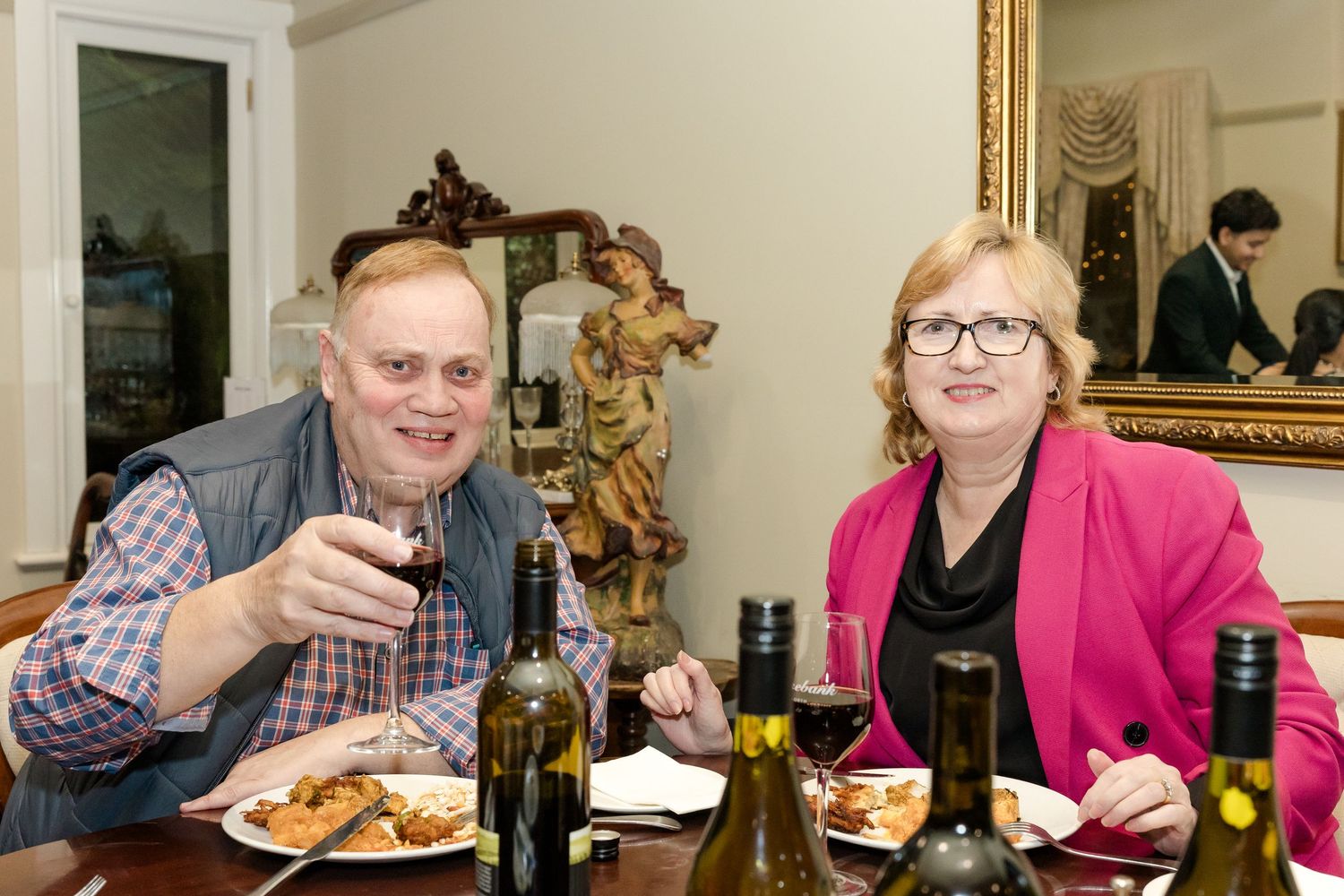 Friends enjoying drinks and conversation at a casual dining gathering.
