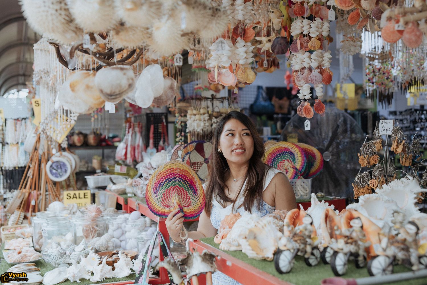 Gift shop display with numerous plush toys, decorative items and hanging ornaments.