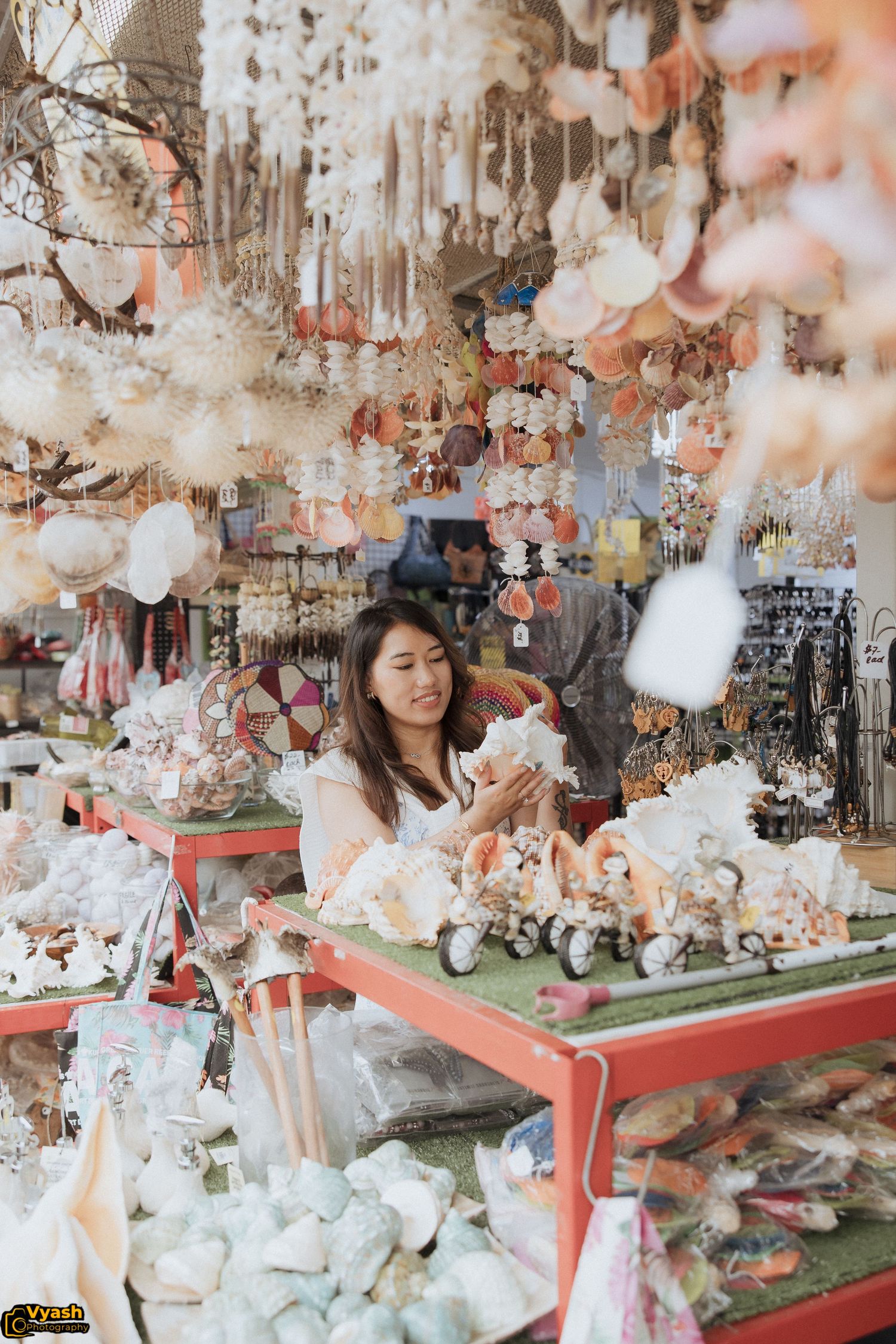 Retail display filled with plush toys, decorative items and hanging ornaments in soft pastel colors.