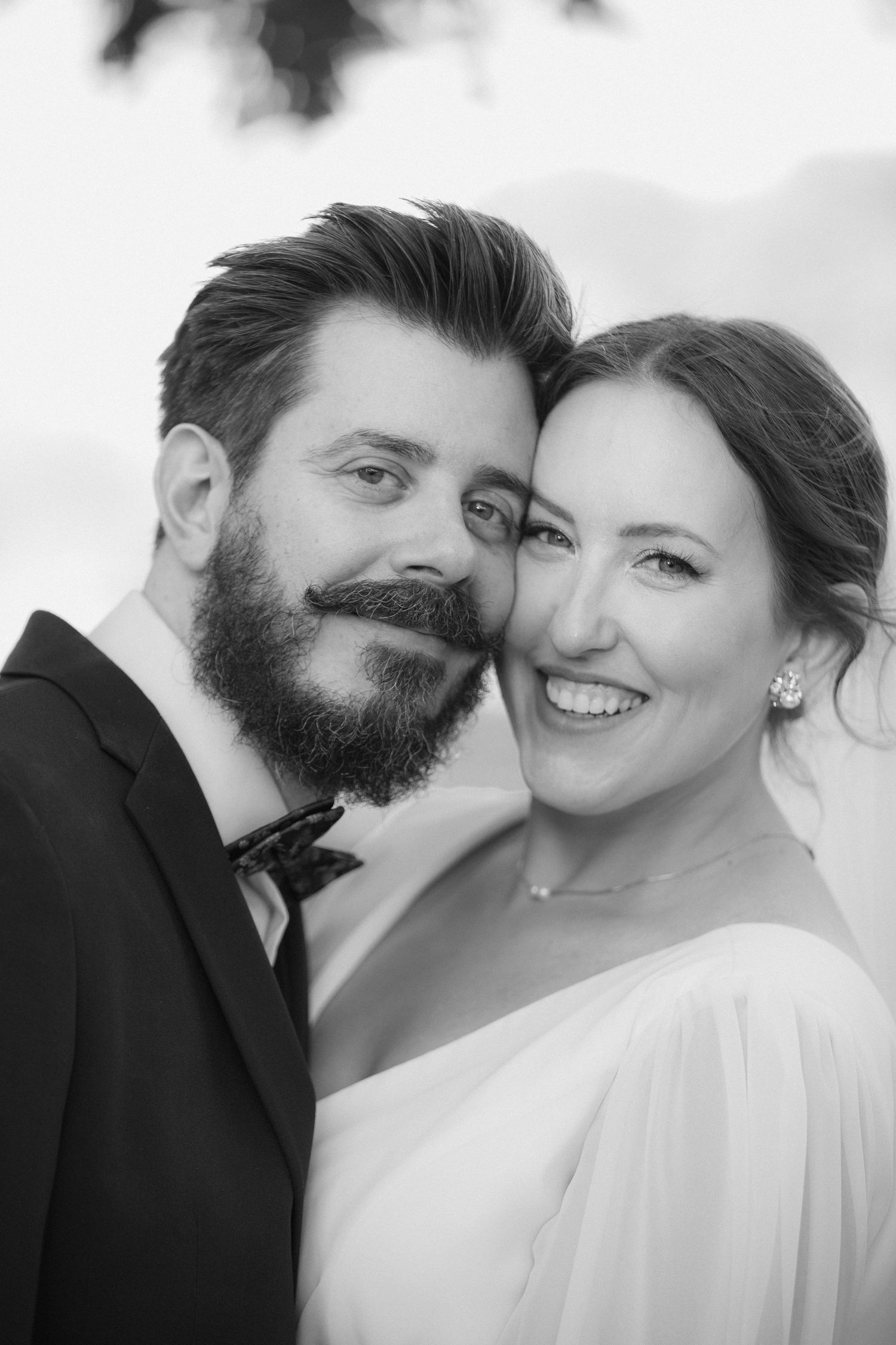 Black and white romantic wedding portraits showing tender moments between newlyweds.