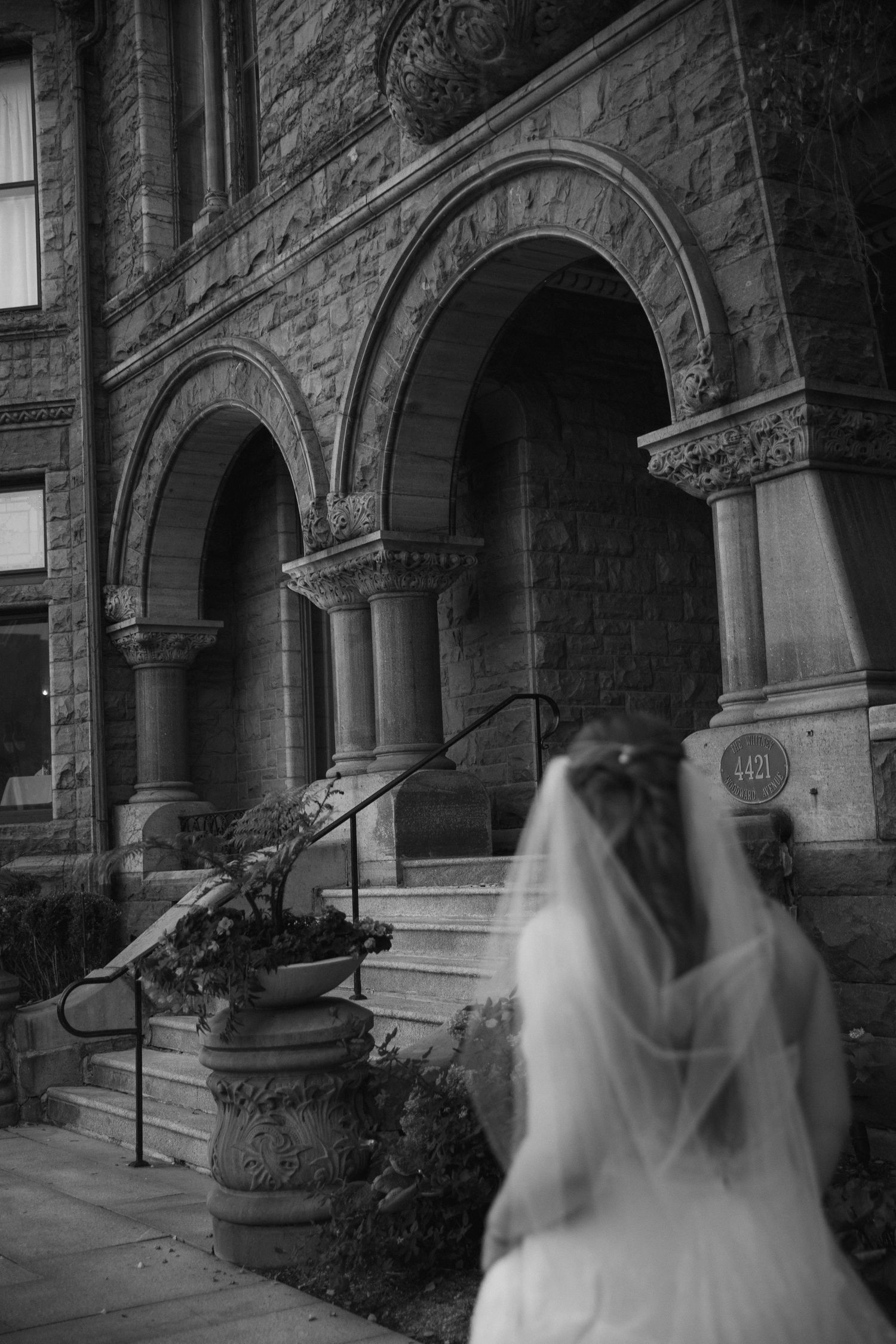 A series of black and white photos showing a ghostly figure in a veil moving through stone archways of a Gothic building.