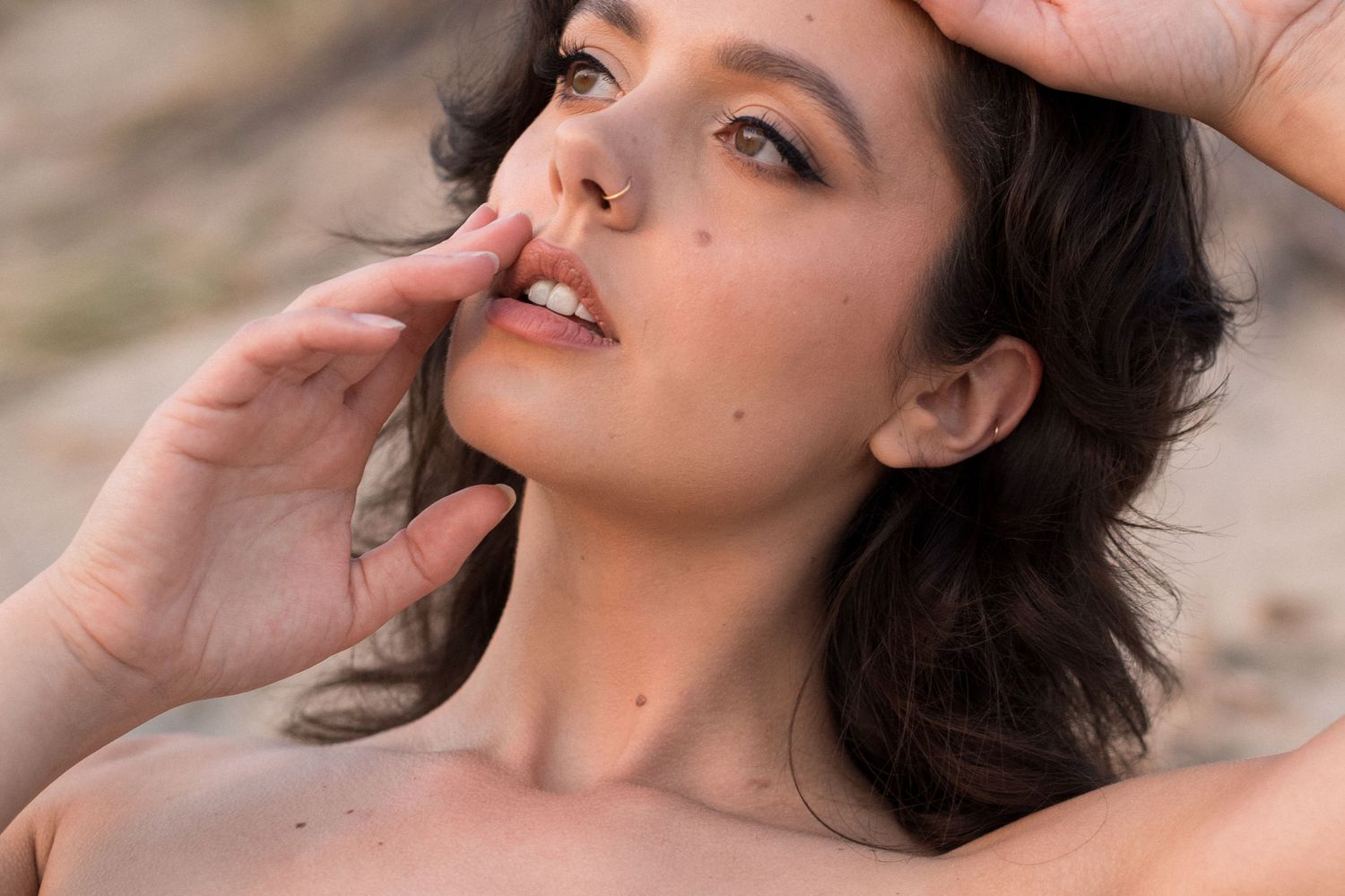 A series of five artistic portrait photographs showing different angles and poses against a natural outdoor background.